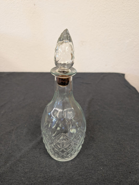 Small clear pressed glass decanter with a diamond pattern and pointed stopper.