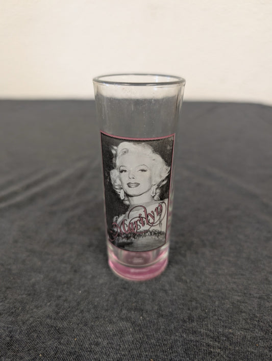Clear tall shot glass featuring Marilyn Monroe with a pink tinted base.