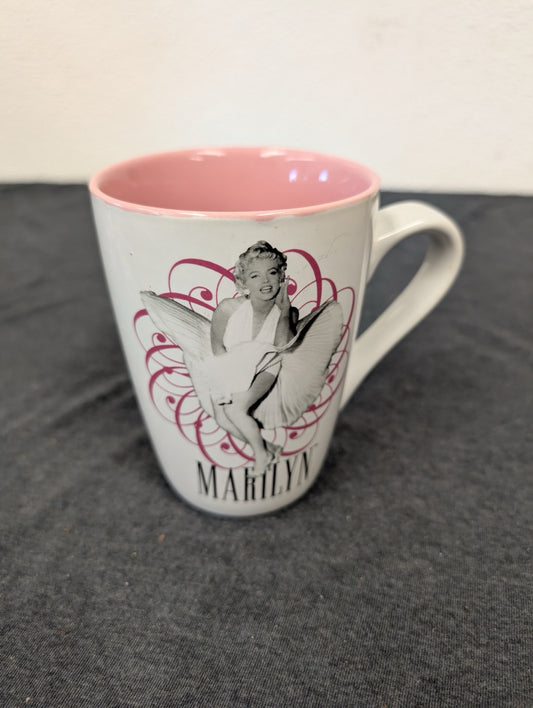 White ceramic mug with Marilyn Monroe in her classic white dress pose, pink interior.