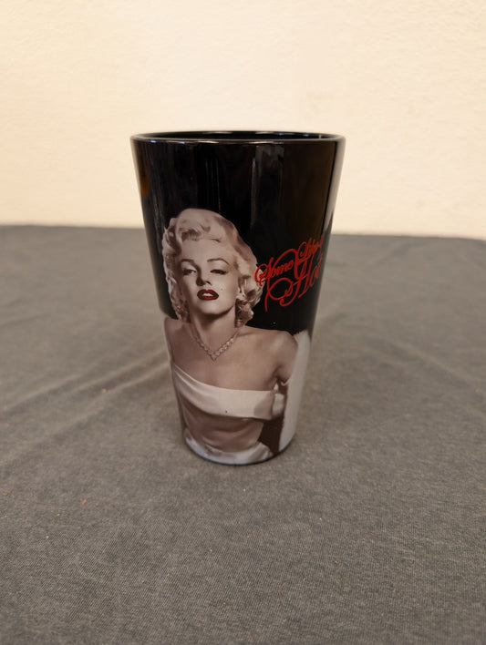 Black pint glass featuring Marilyn Monroe and red Some Like It Hot text