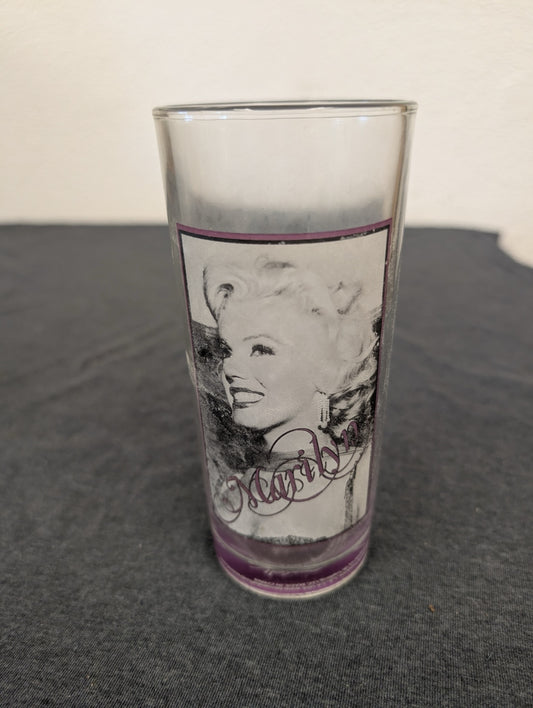 Glass tumbler showing a close-up black and white smiling portrait of Marilyn Monroe