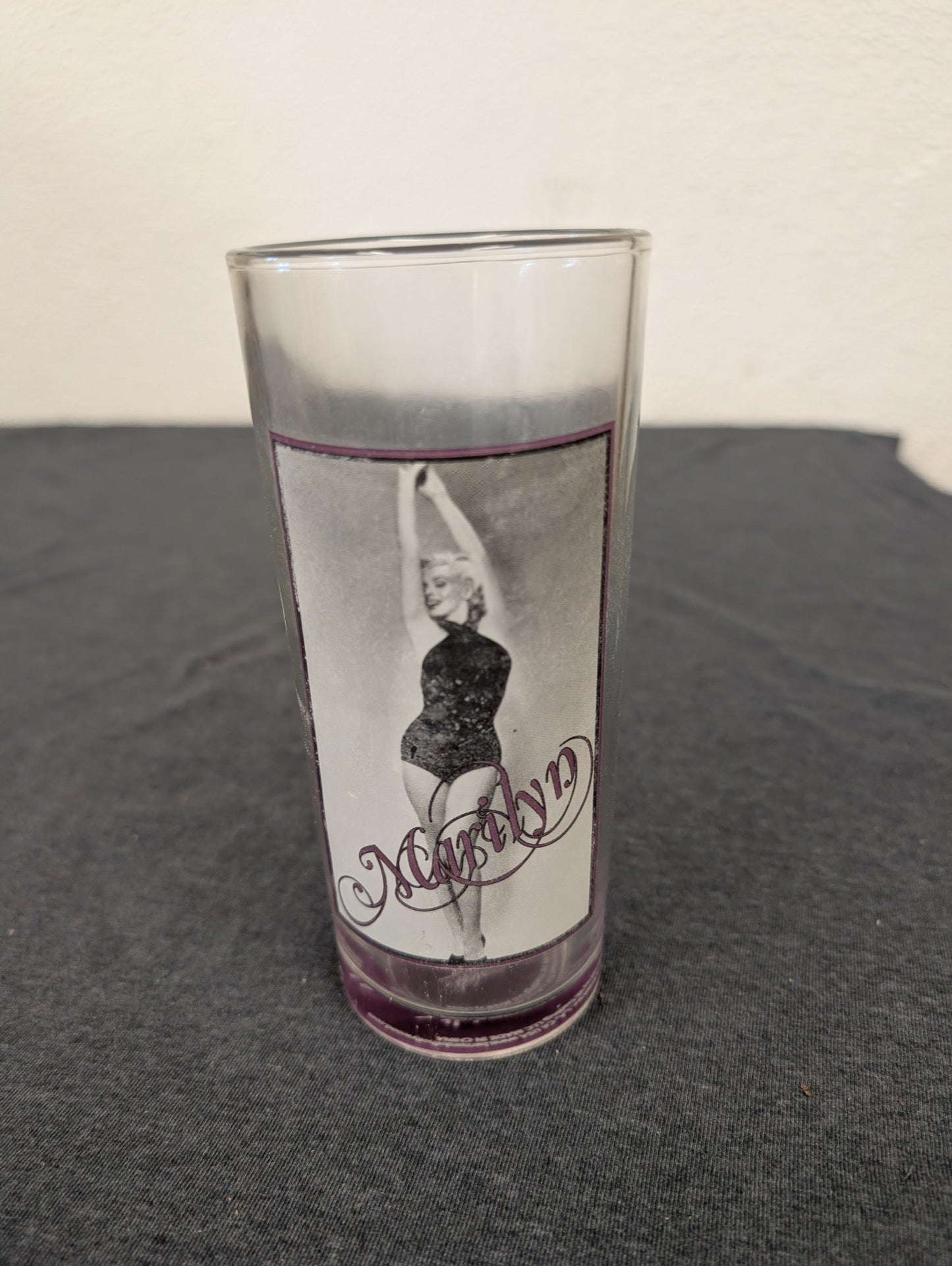 Clear tall drinking glass with a picture of Marilyn Monroe in a black outfit