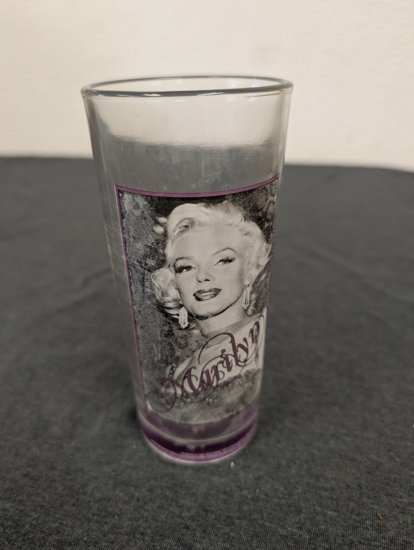 Clear tumbler with Marilyn Monroe face portrait and a purple border frame