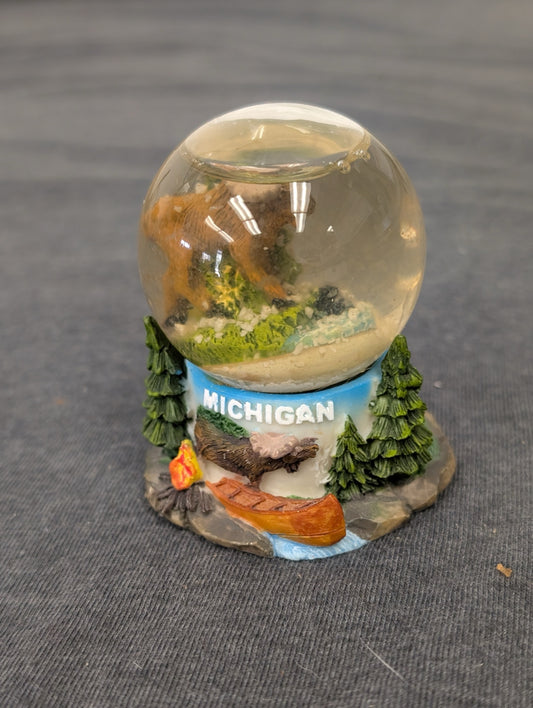 Small snow globe featuring a moose and canoe with "MICHIGAN" text