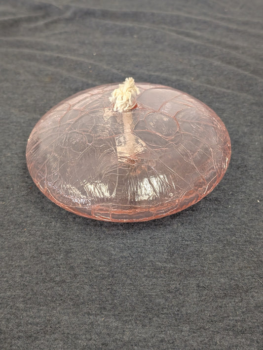 Flat round pink crackle glass oil lamp with a white wick