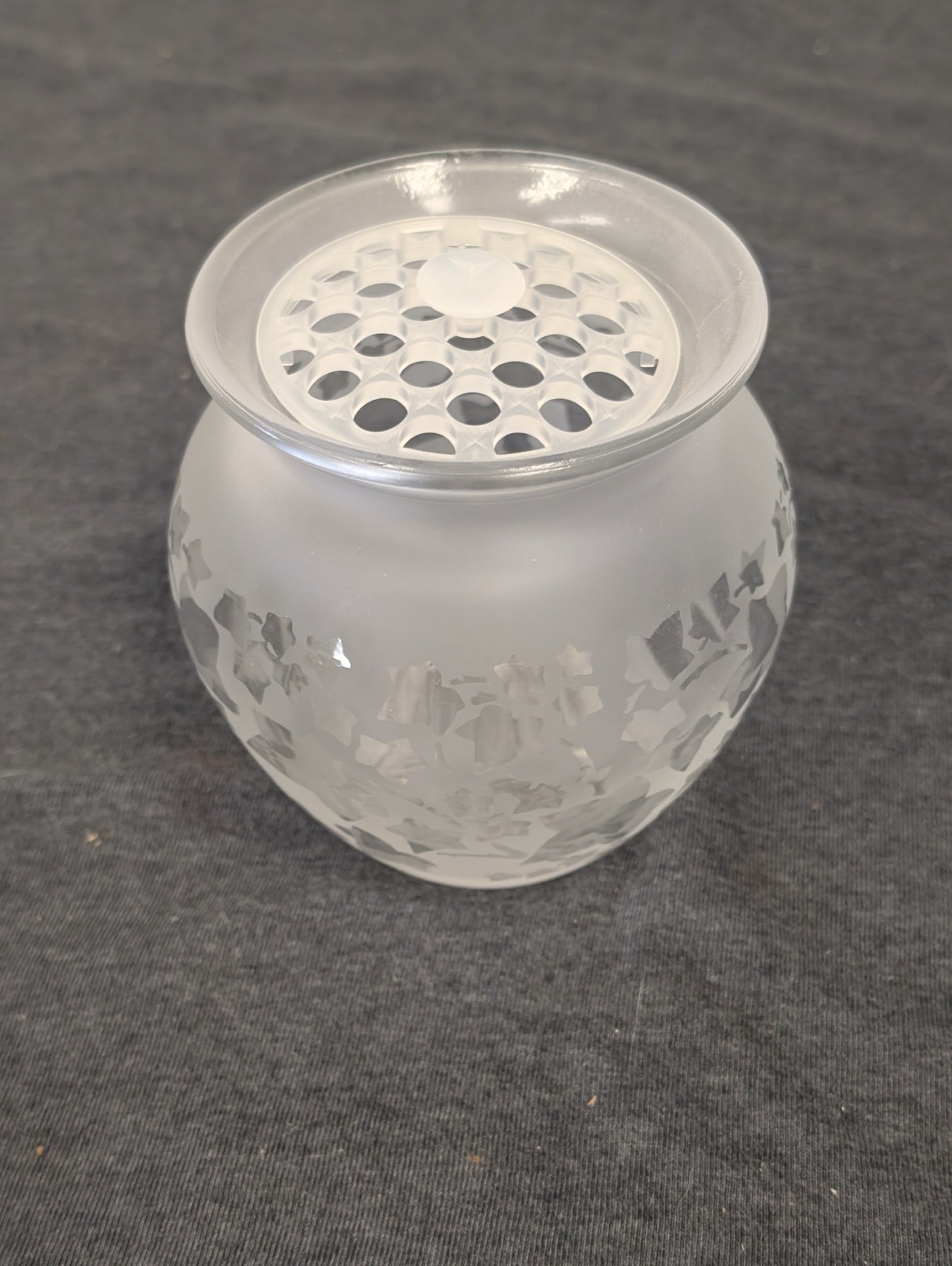 Frosted glass bowl with clear glass flower frog top featuring etched ivy patterns.