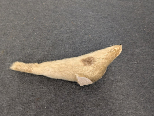 Small figurine of a seal made out of light brown animal fur.