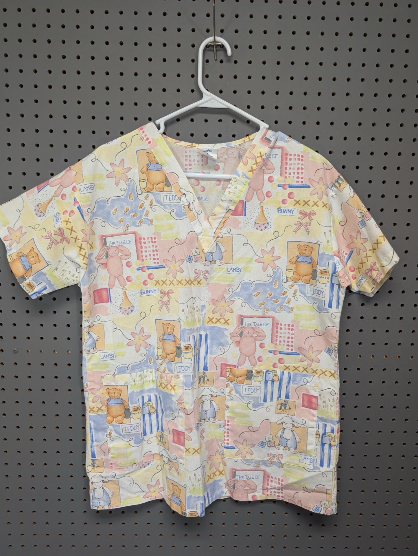 Front view of Medline vintage pediatric scrub top with animals