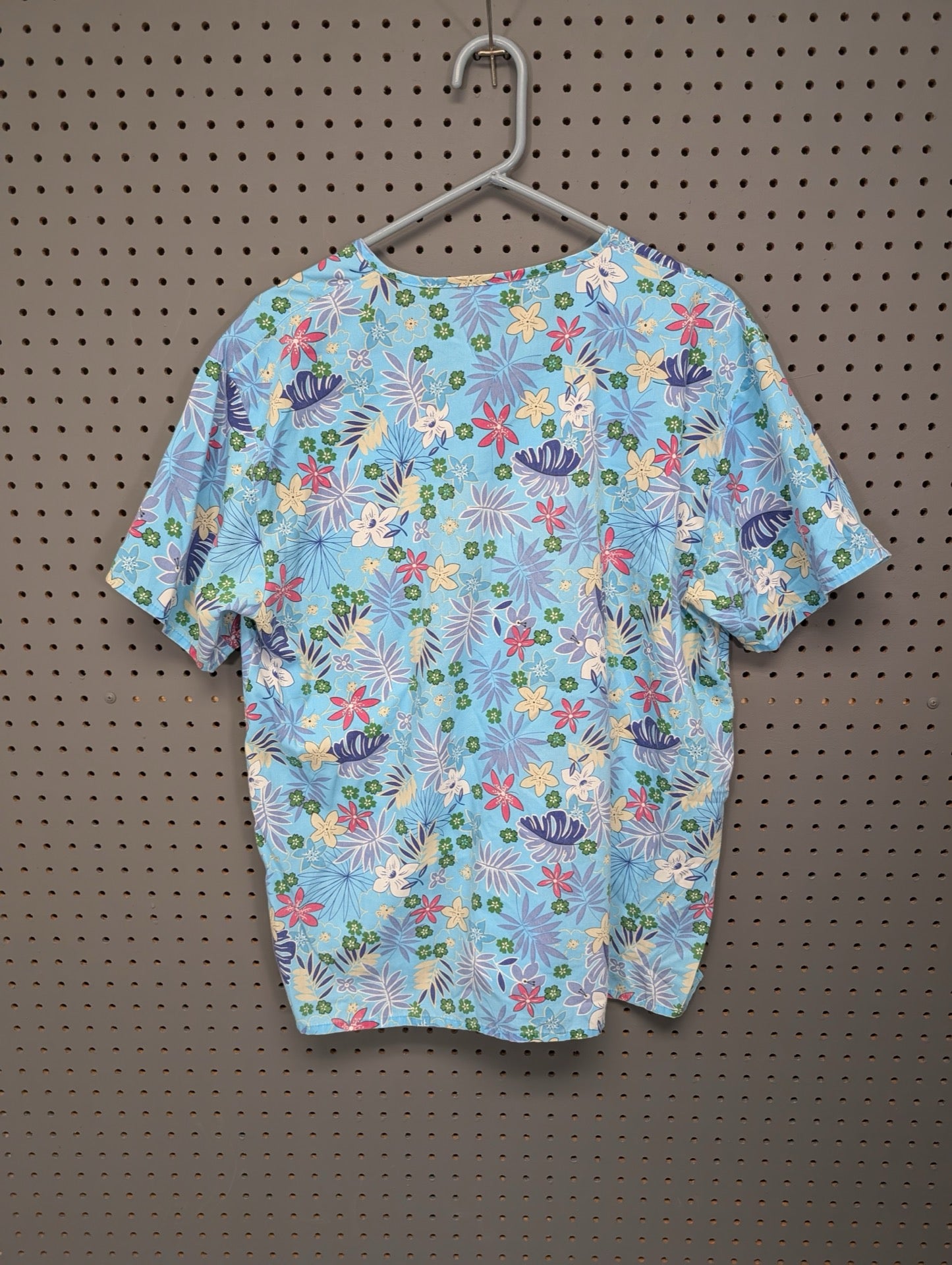 Back view of EXPO tropical floral scrub top