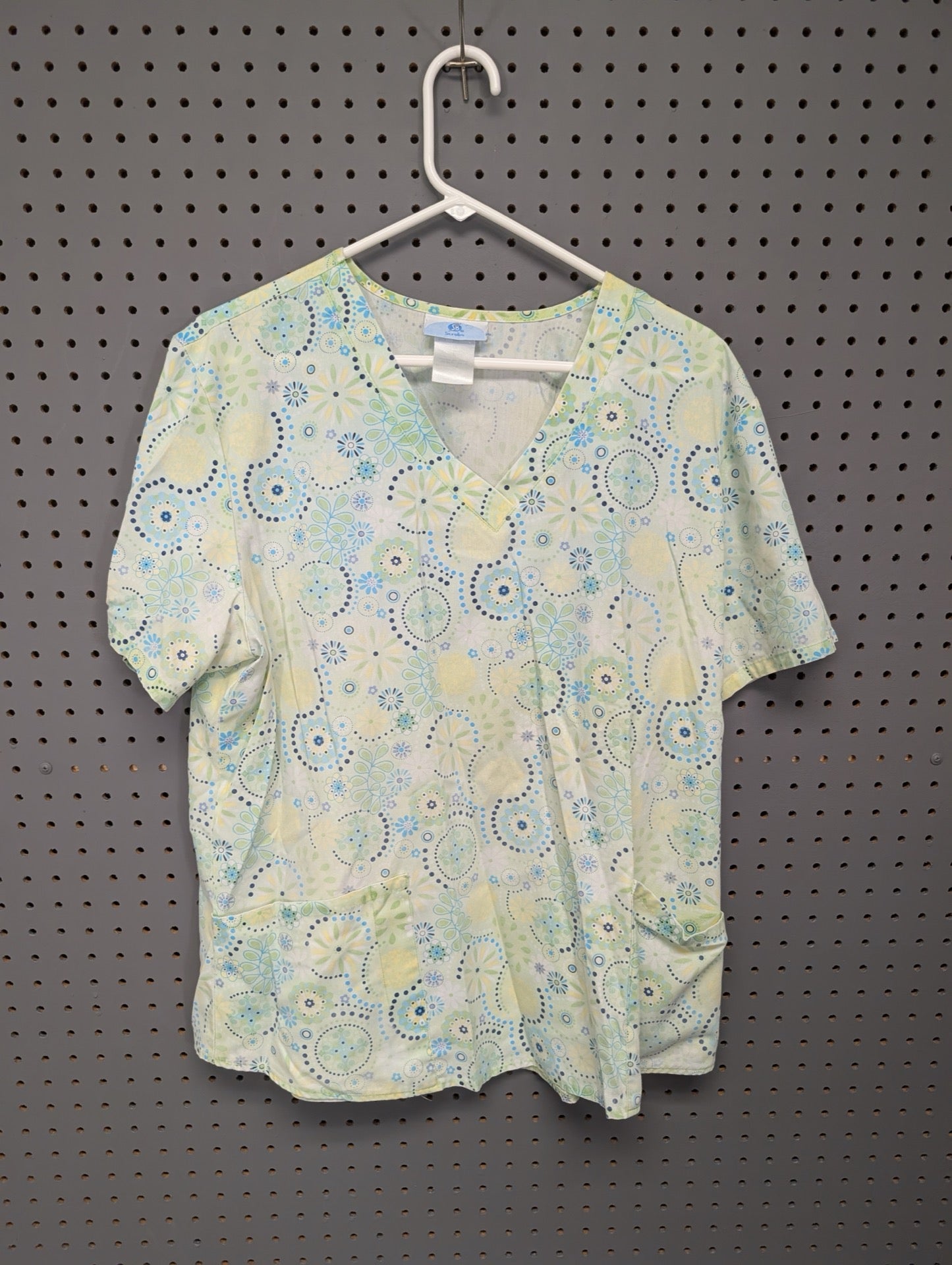 Front view of SB Scrubs geometric floral scrub top