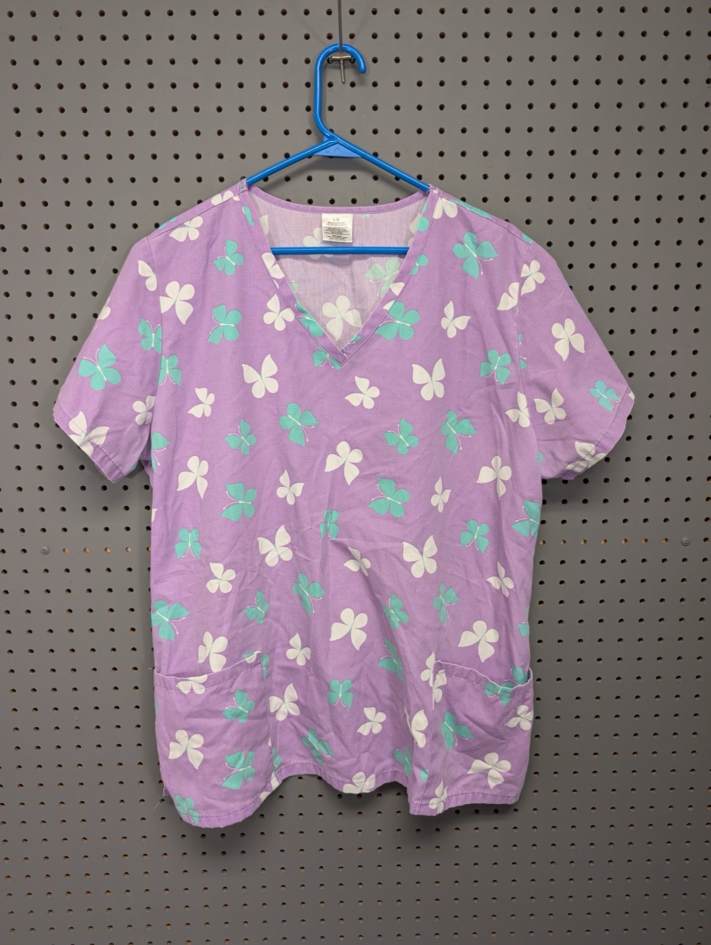 Front view of purple butterfly scrub top