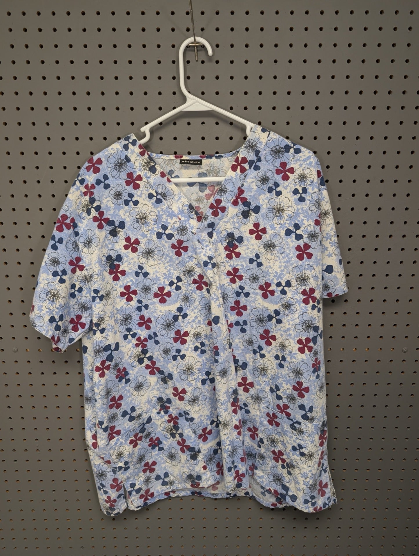 Front view of Absolute blue and red floral scrub top