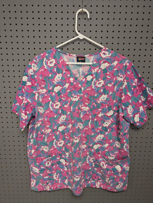 Front view of Brisco Apparel pink and teal floral scrub top