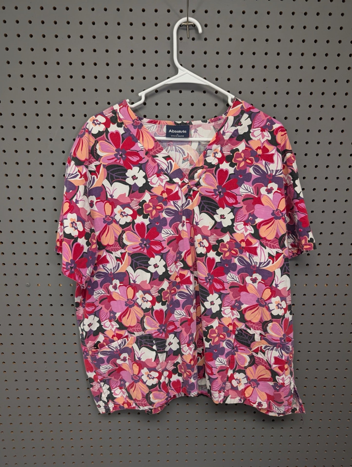 Front view of Absolute pink floral scrub top