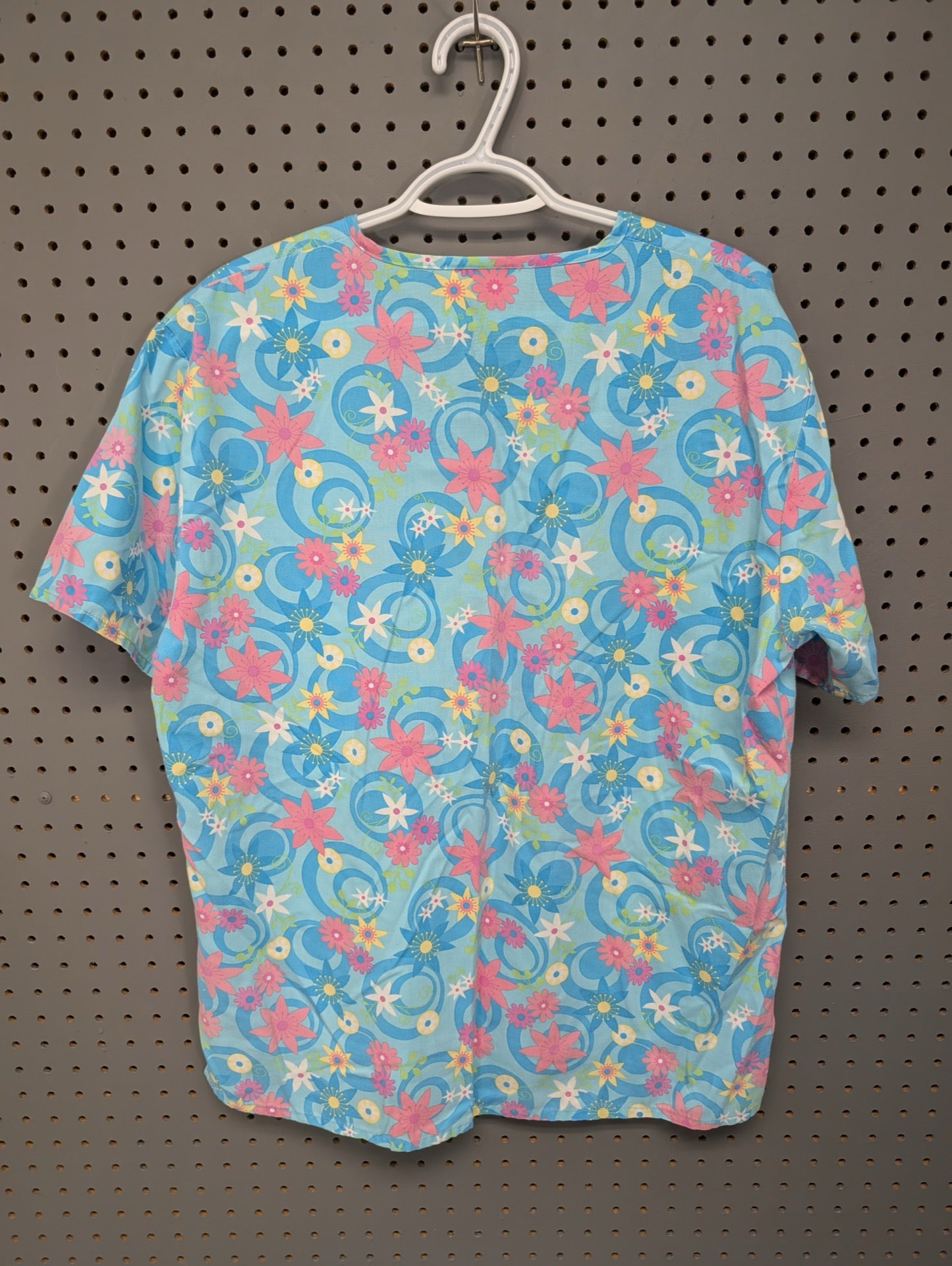 Back view of EXPO blue geometric scrub top