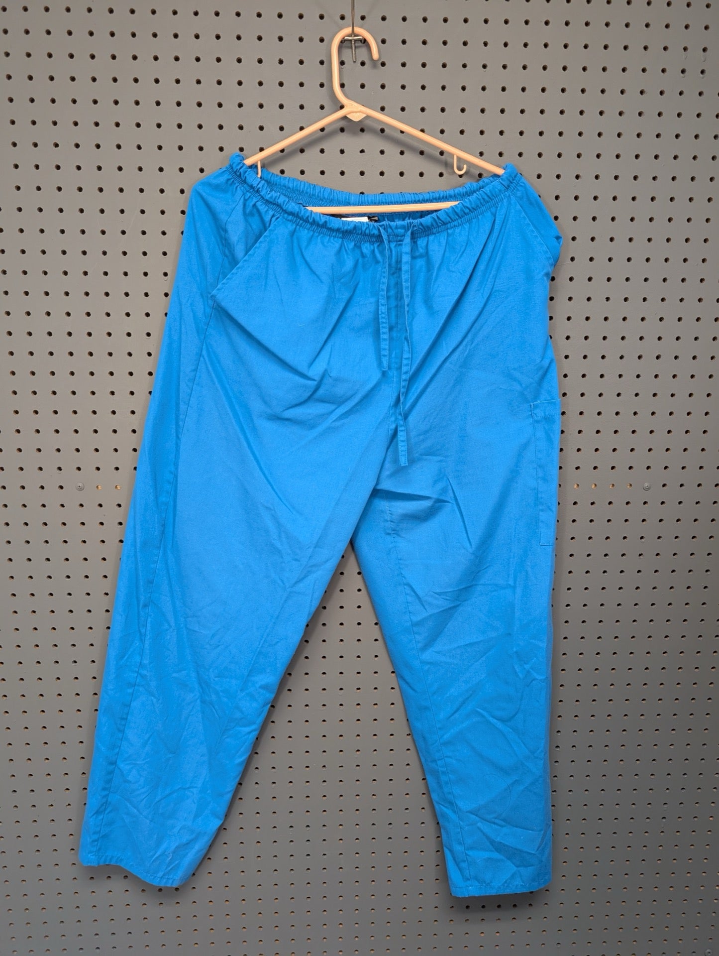 Front view of Cassandra O bright blue scrub pants