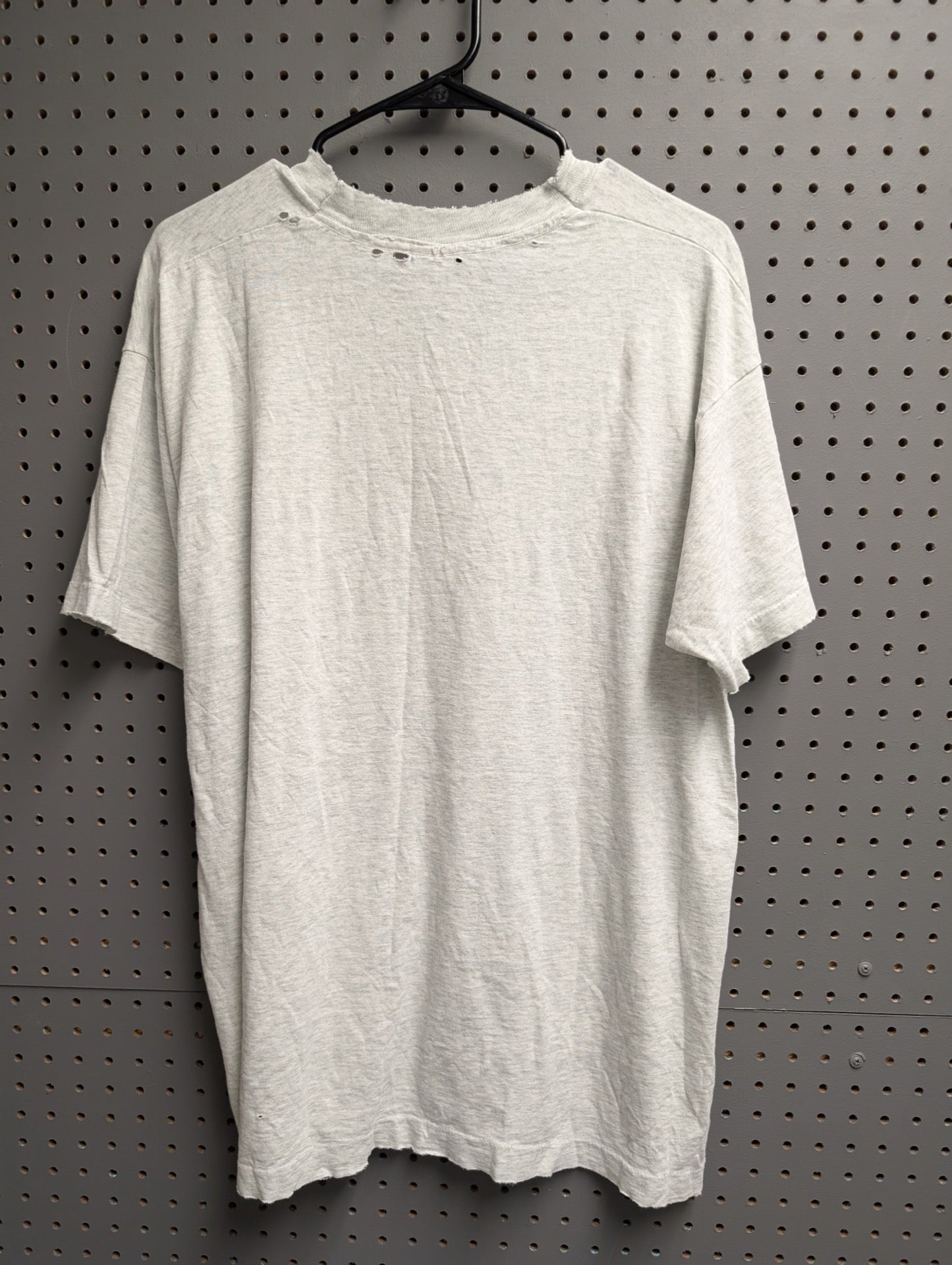Back view of distressed University of Michigan t-shirt with holes