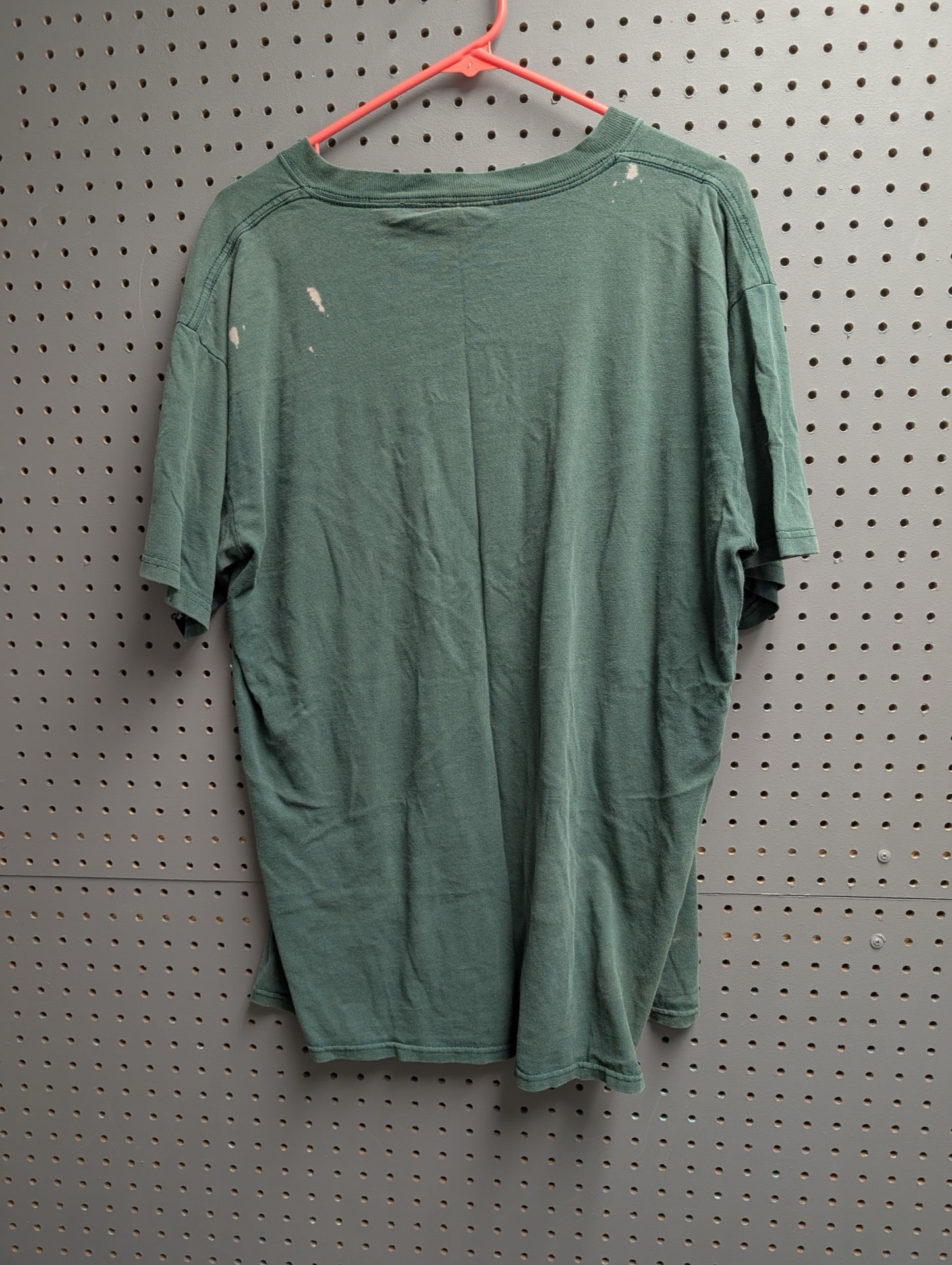 Back view of green Miami Hurricanes t-shirt showing bleach spots