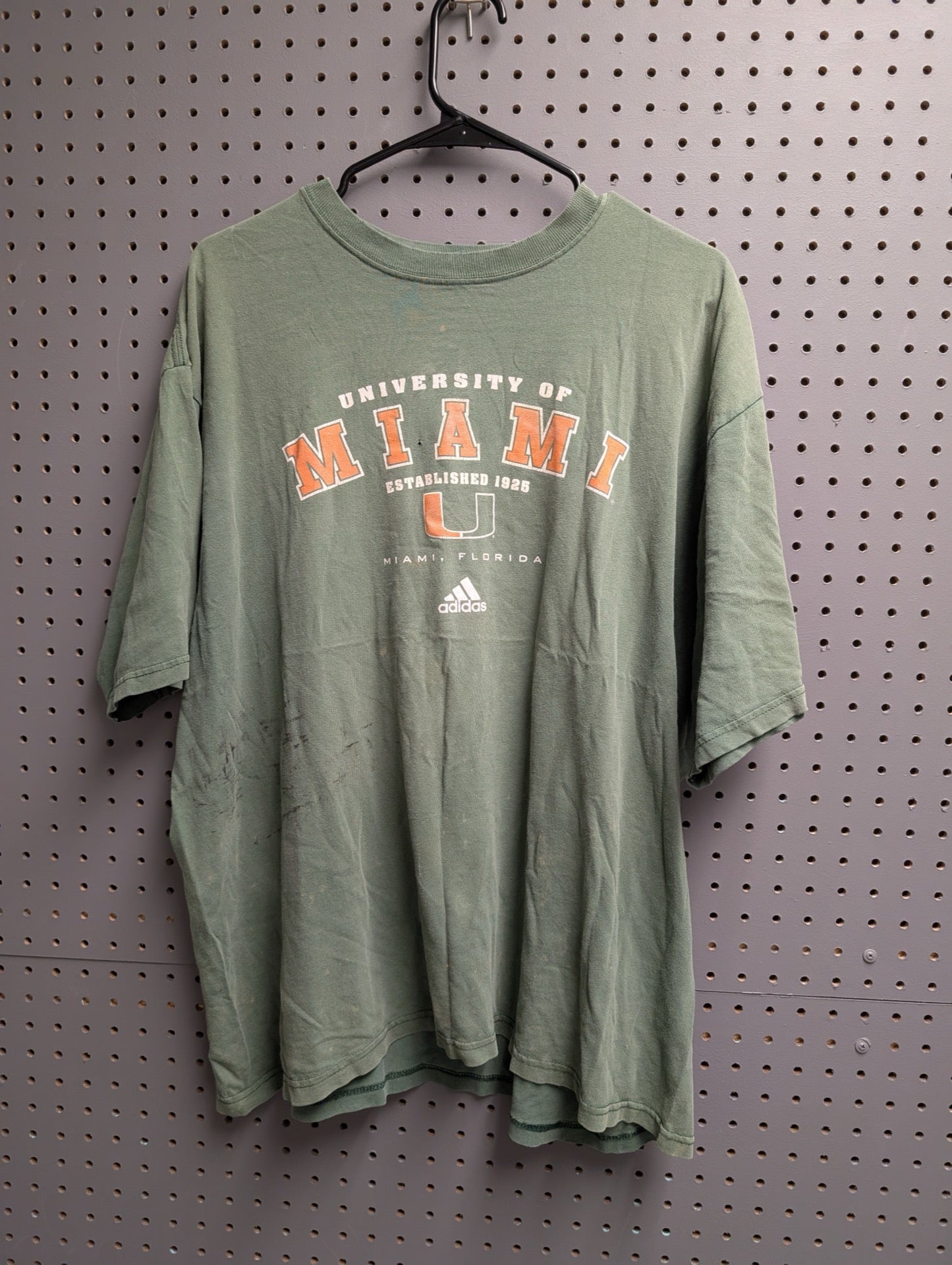 Front view of green Adidas Miami Hurricanes t-shirt