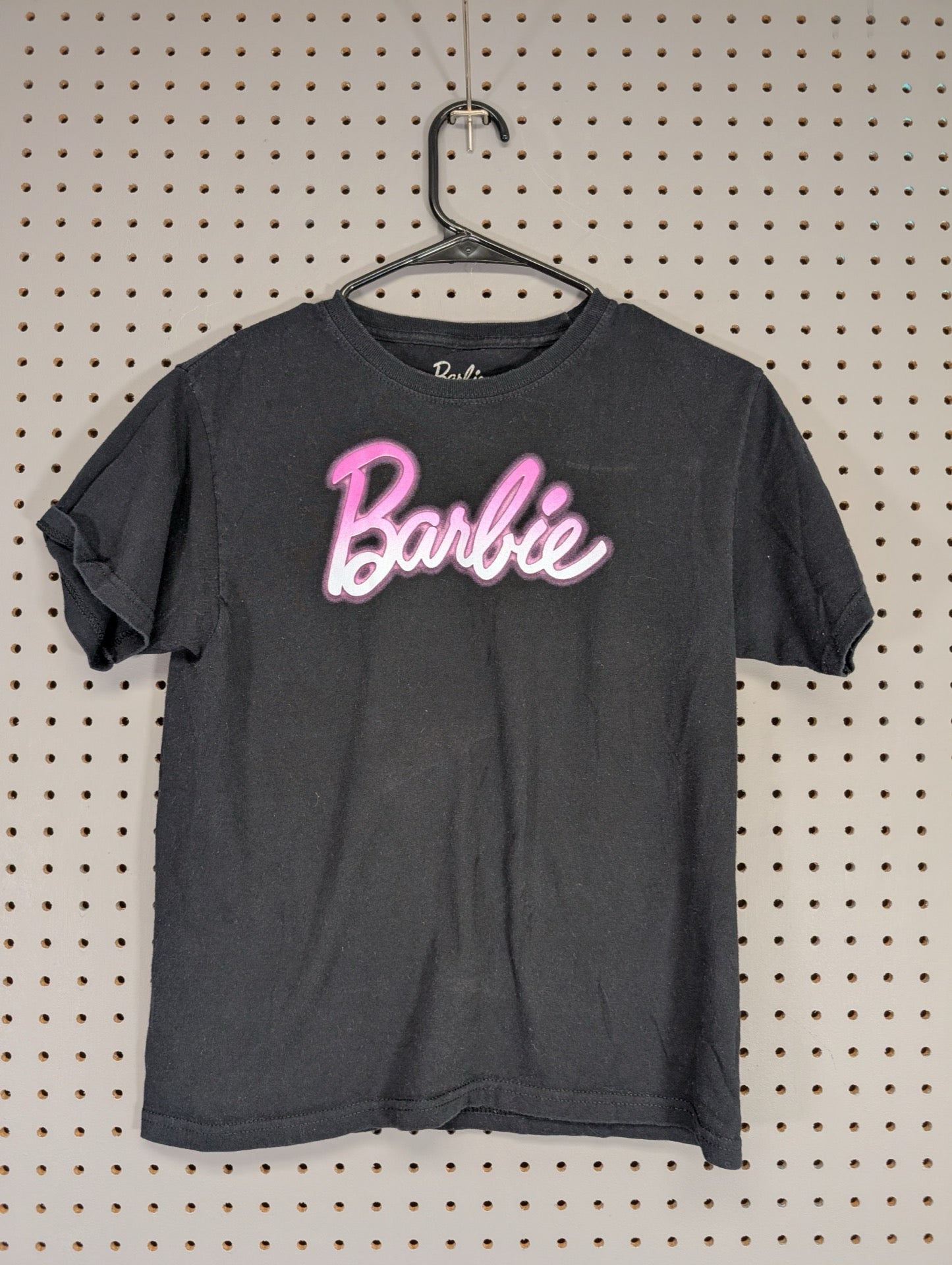 Front view of black youth Barbie t-shirt with pink logo