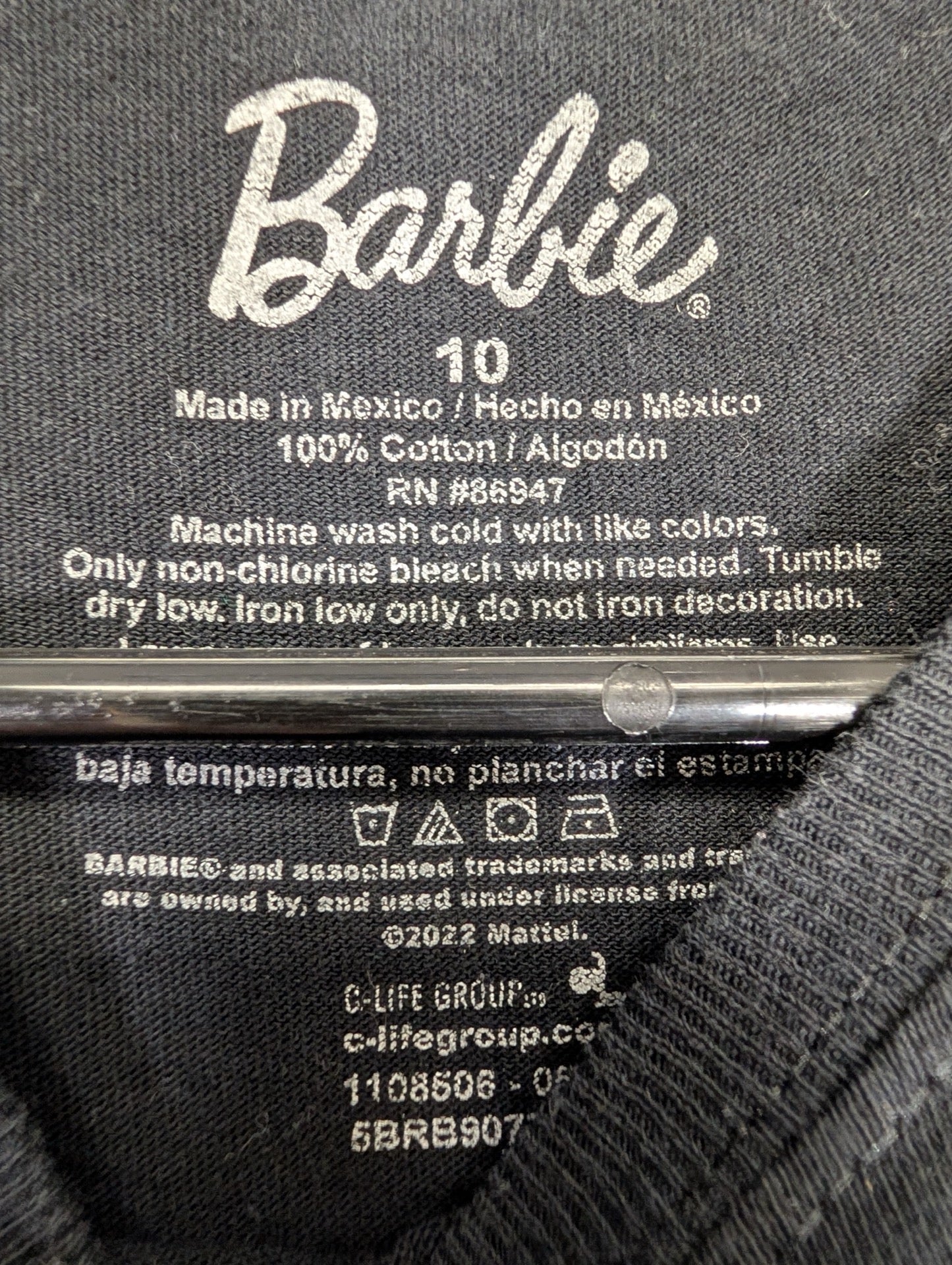 Printed Barbie neck tag showing youth size 10
