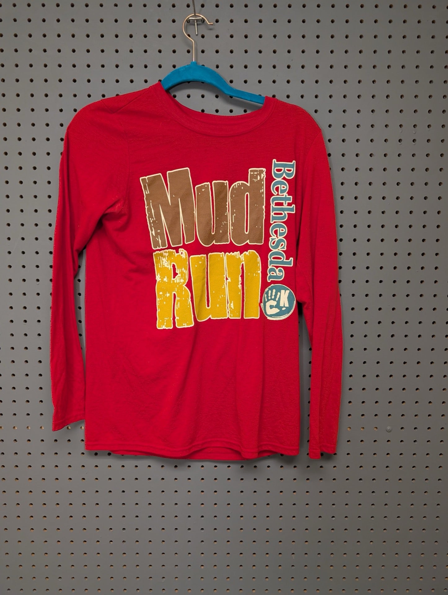 Front view of red Bethesda Mud Run long sleeve shirt
