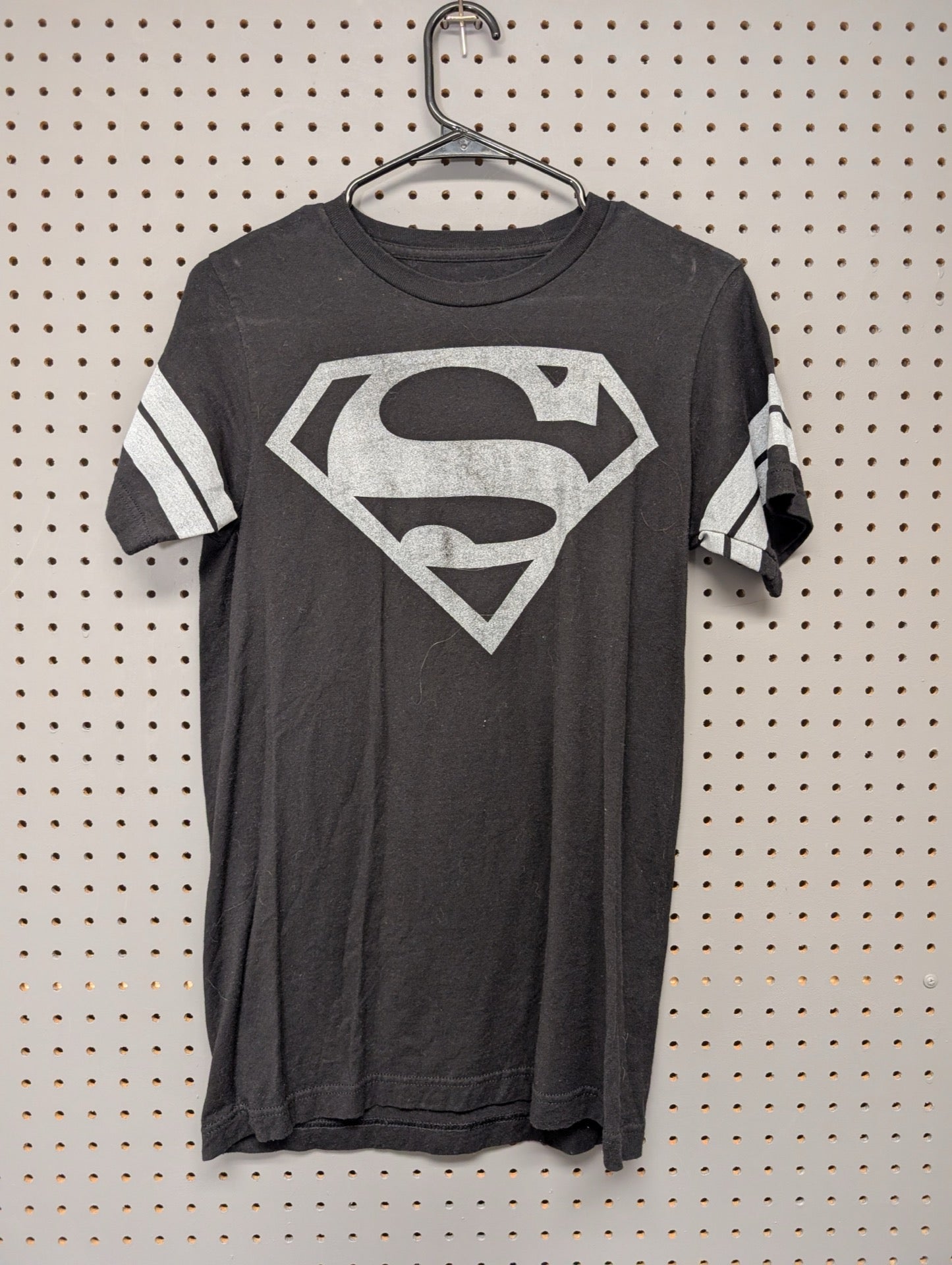 Front of black Superman t-shirt with silver logo and sleeve stripes