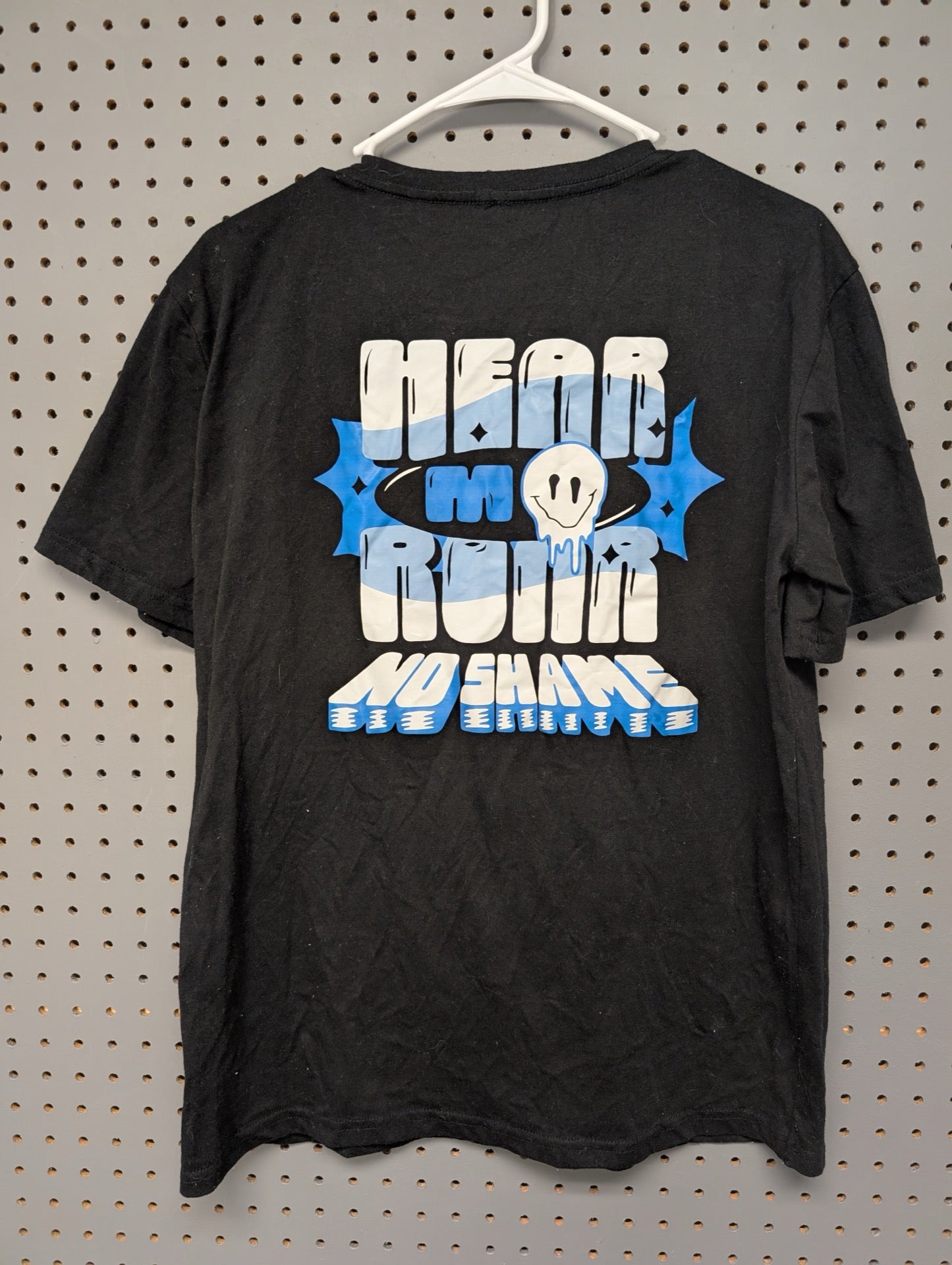 Back of shirt showing Hear My Roar smiley graphic