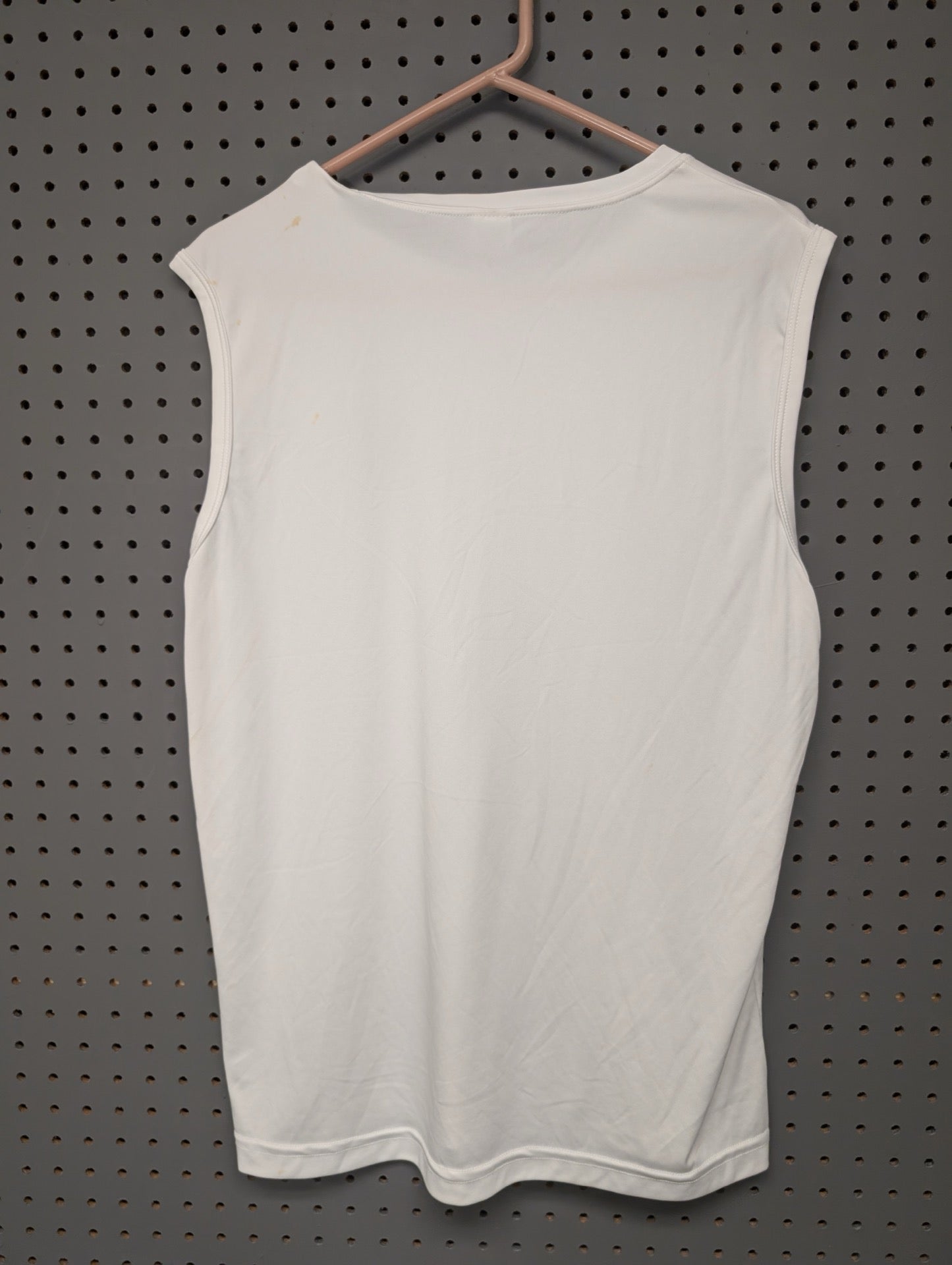 Back of white sleeveless shirt showing minor stains