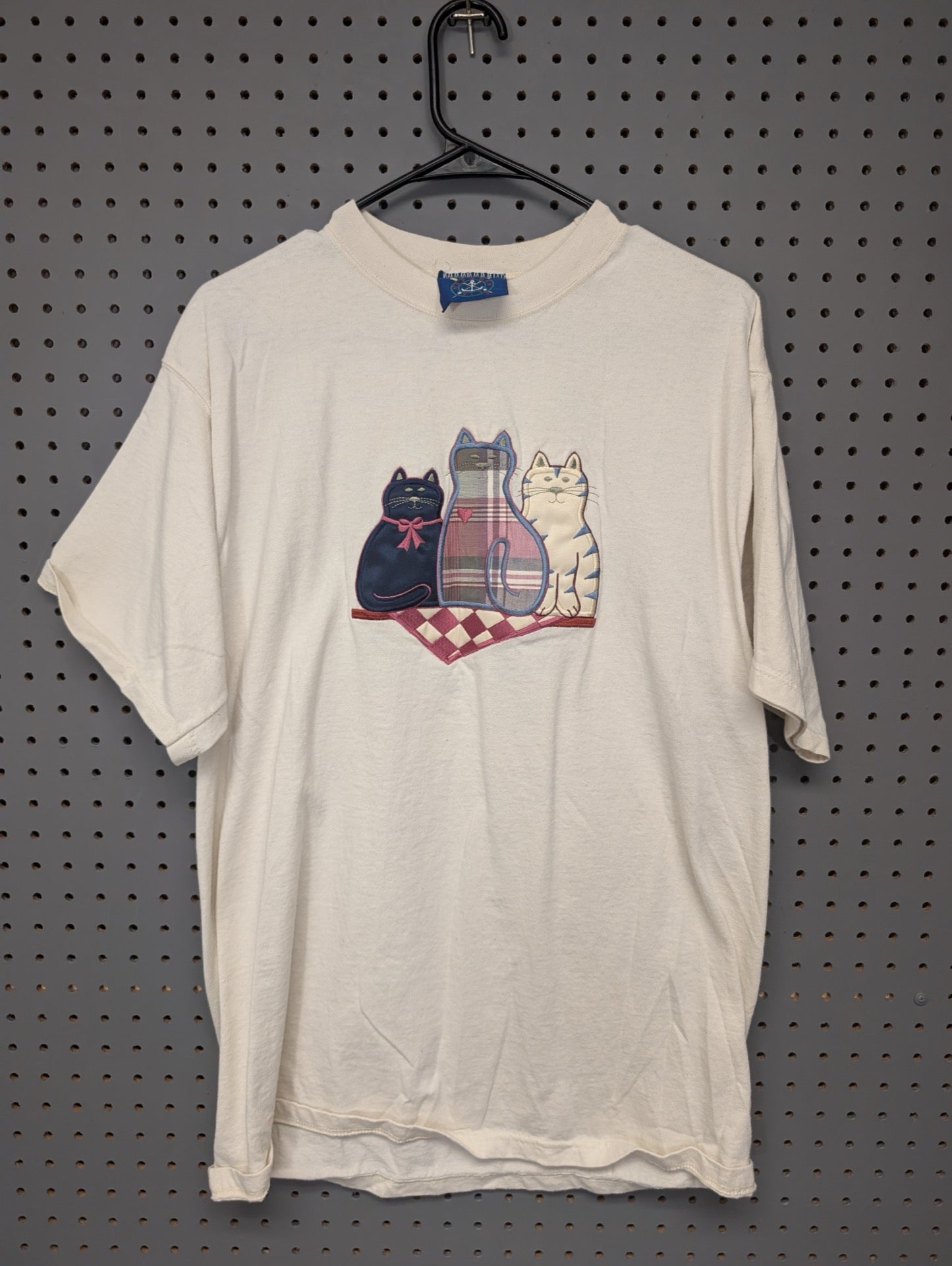 Front of cream t-shirt with embroidered cats