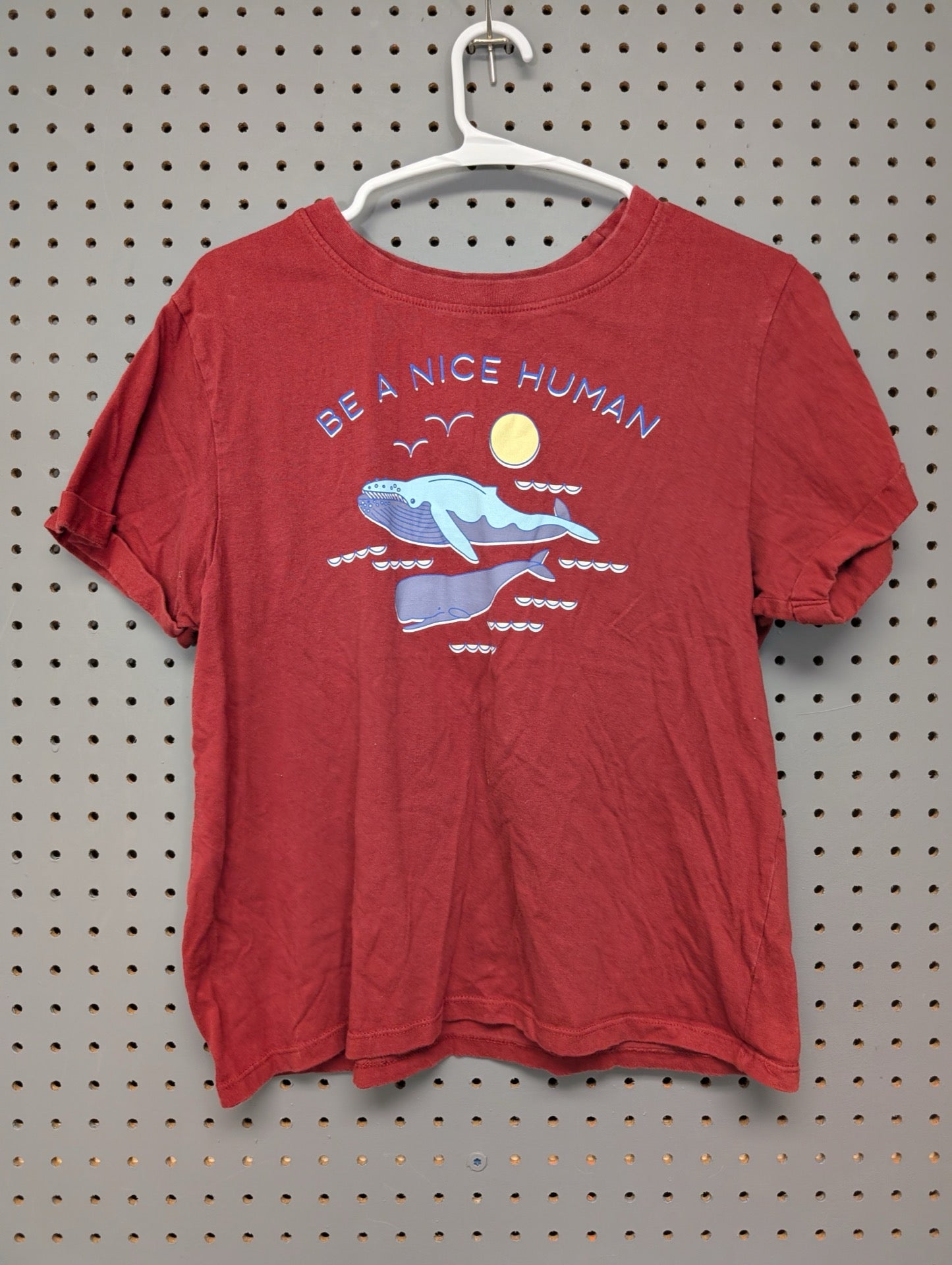 Front of red t-shirt with Be A Nice Human whale graphic