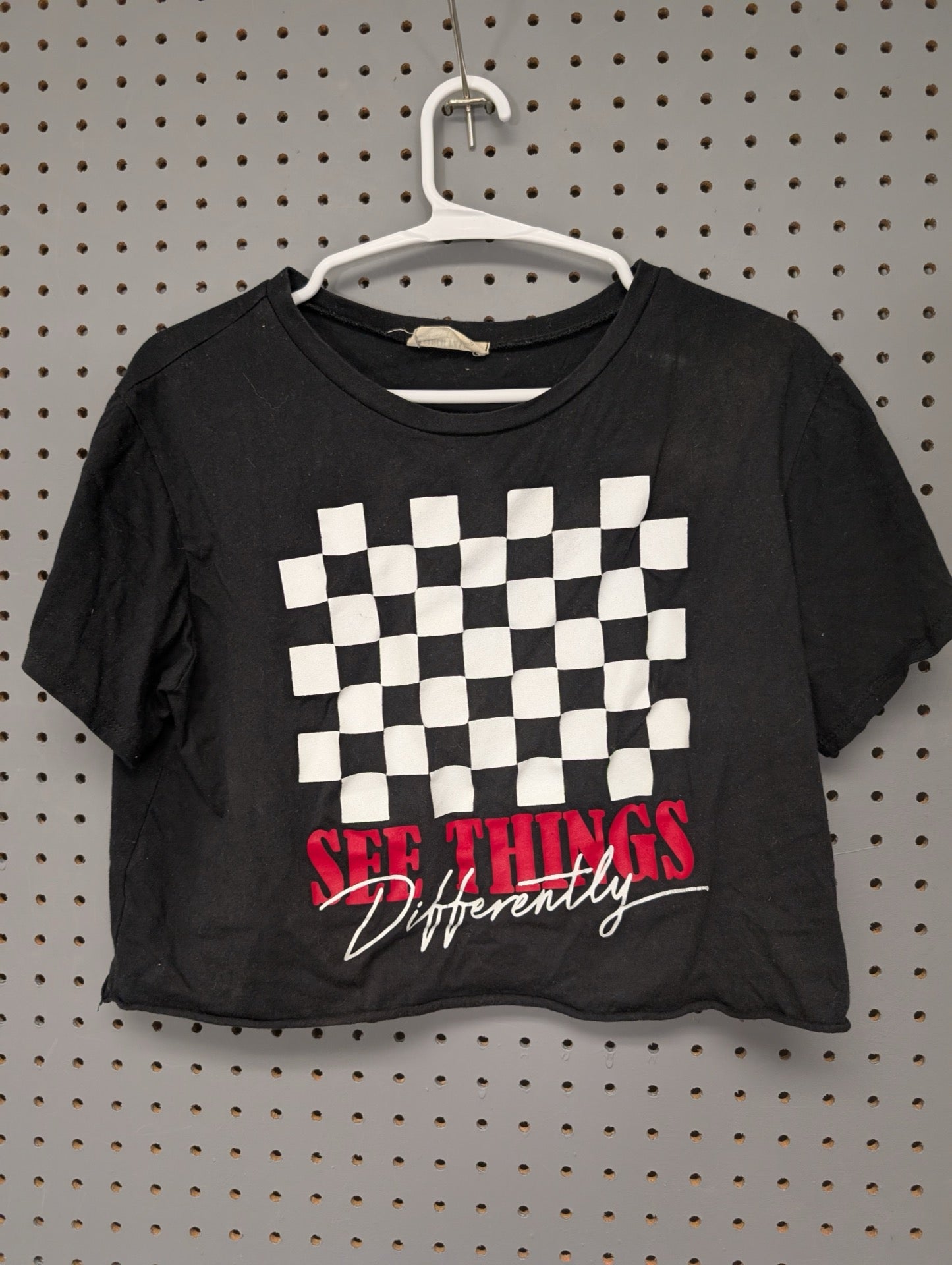 Front of black crop top with checkerboard graphic