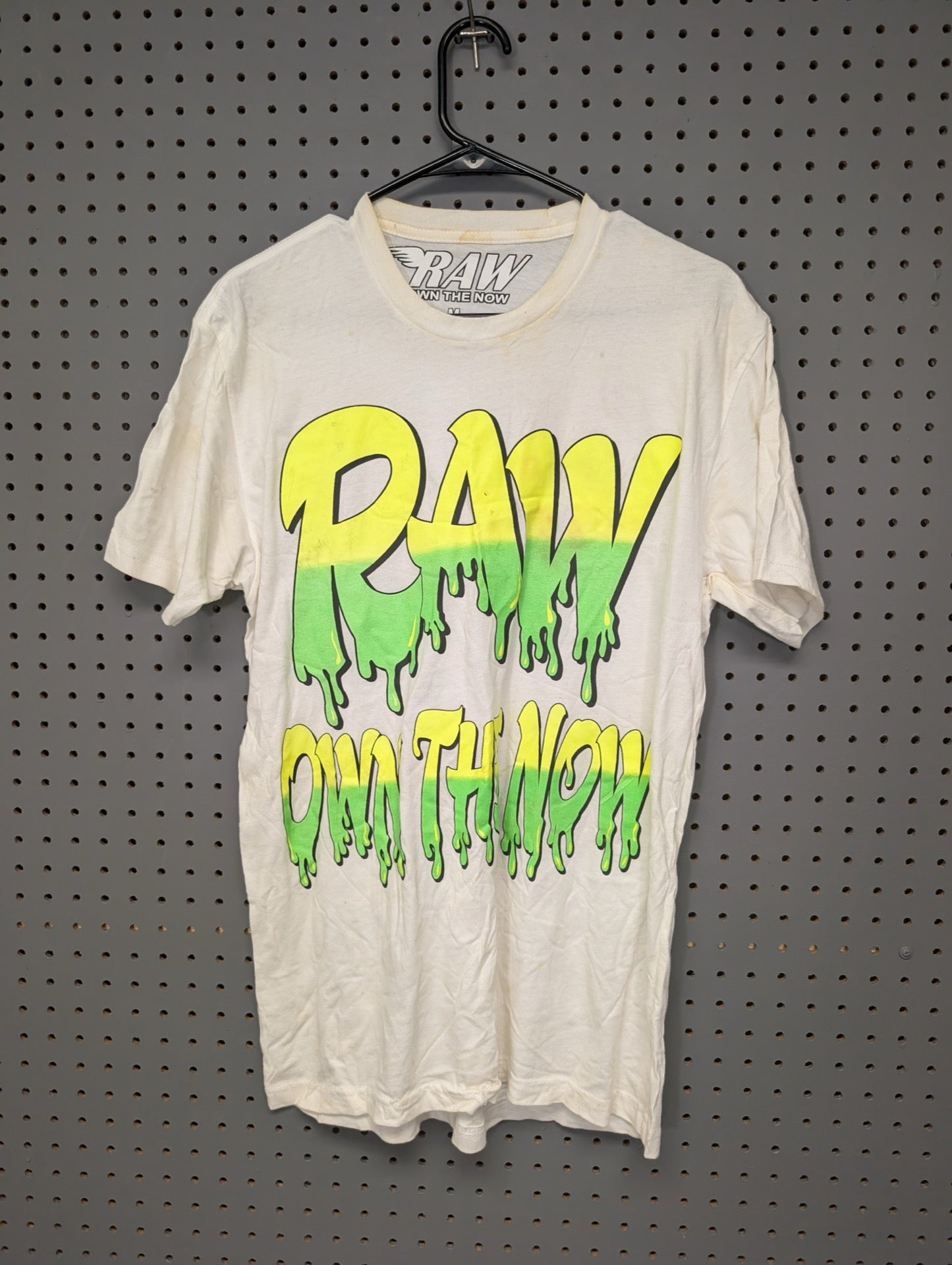 Front of white RAW t-shirt with neon slime graphic showing stains