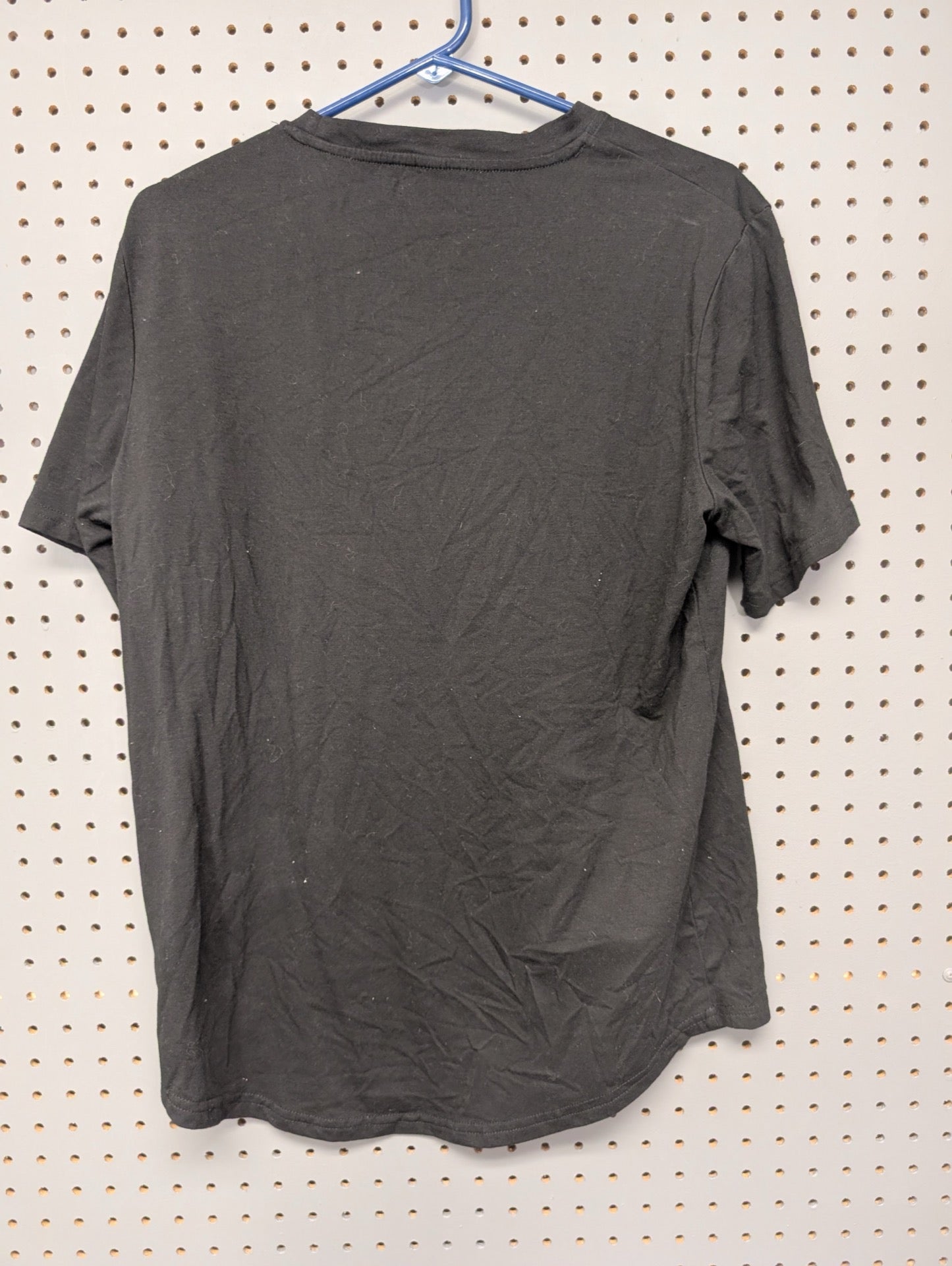 Back of black Shein t-shirt showing curved hem