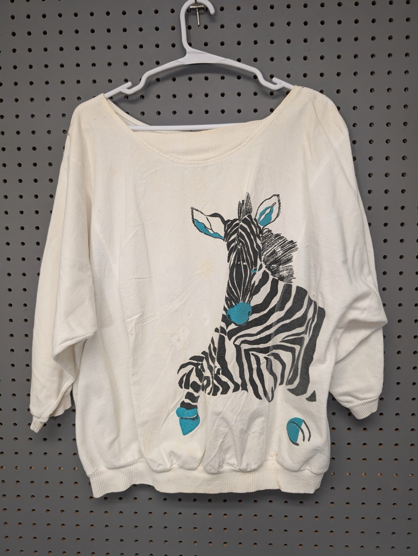 Front of white 80s slouchy sweatshirt with abstract zebra graphic