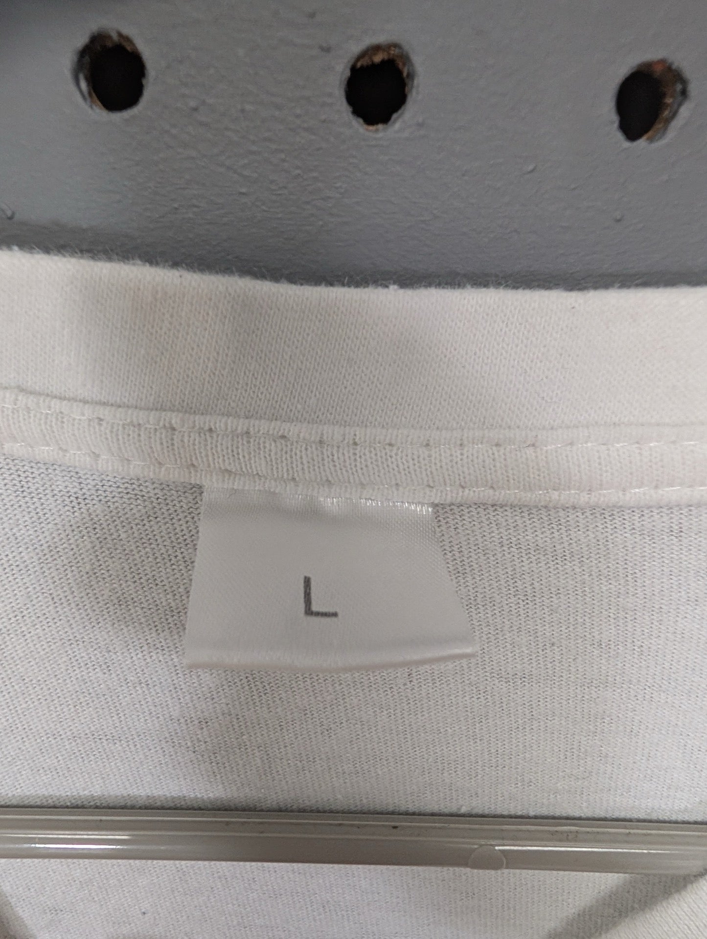 Size Large tag on white t-shirt