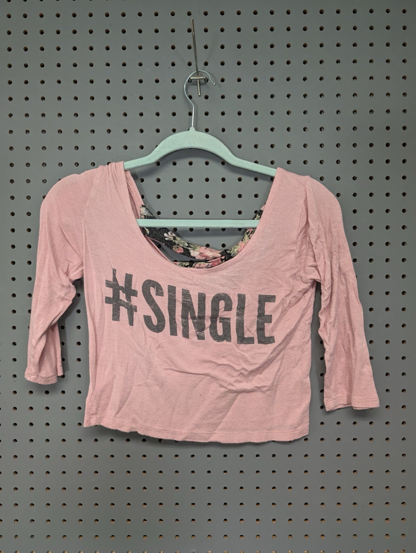 Front view of pink Body Central crop top with single graphic