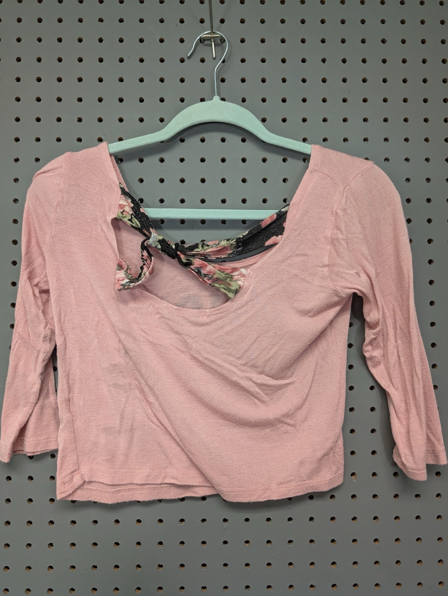 Back view showing floral tie detail on pink crop top