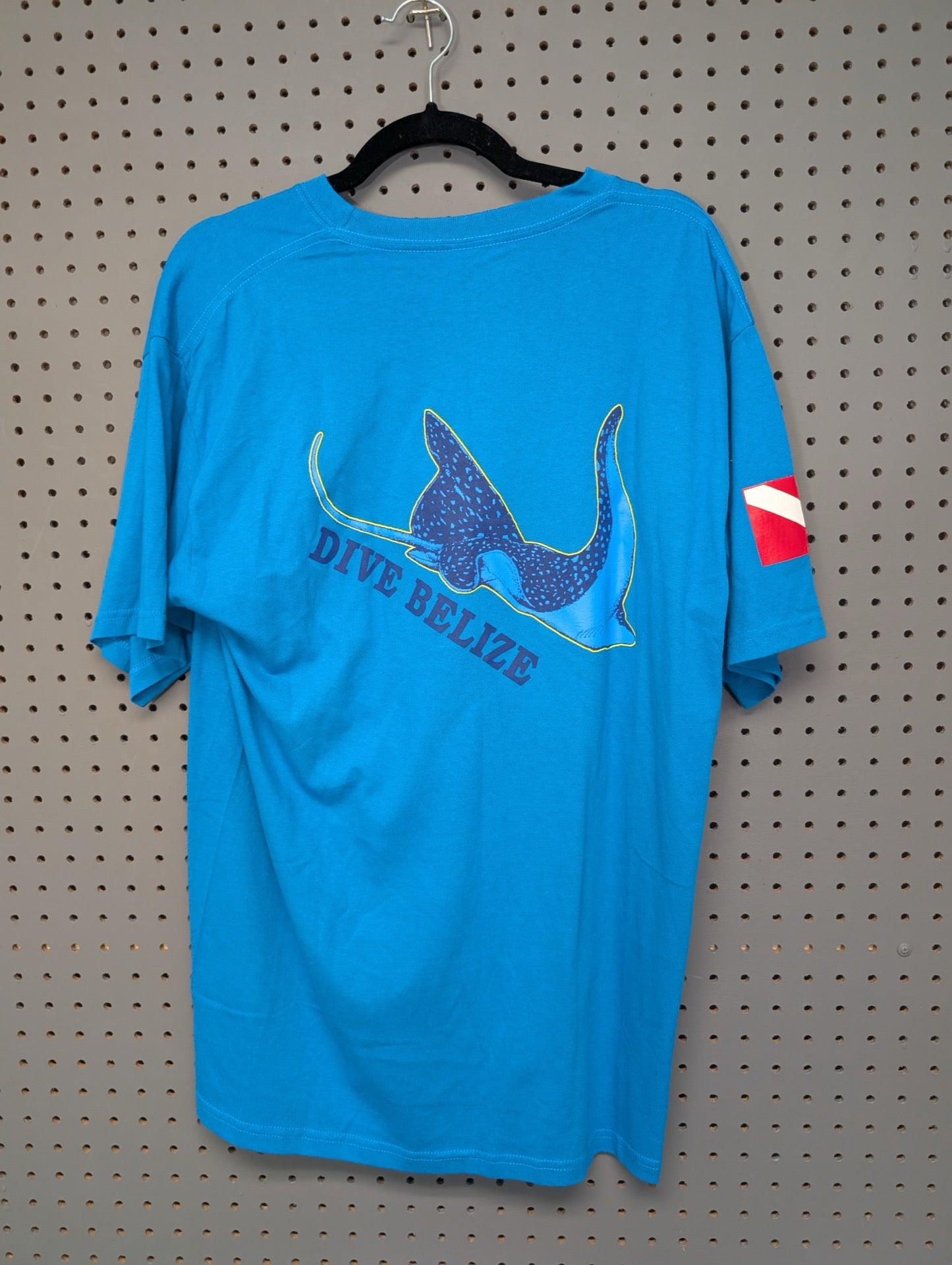 Back of blue tee showing Dive Belize eagle ray graphic