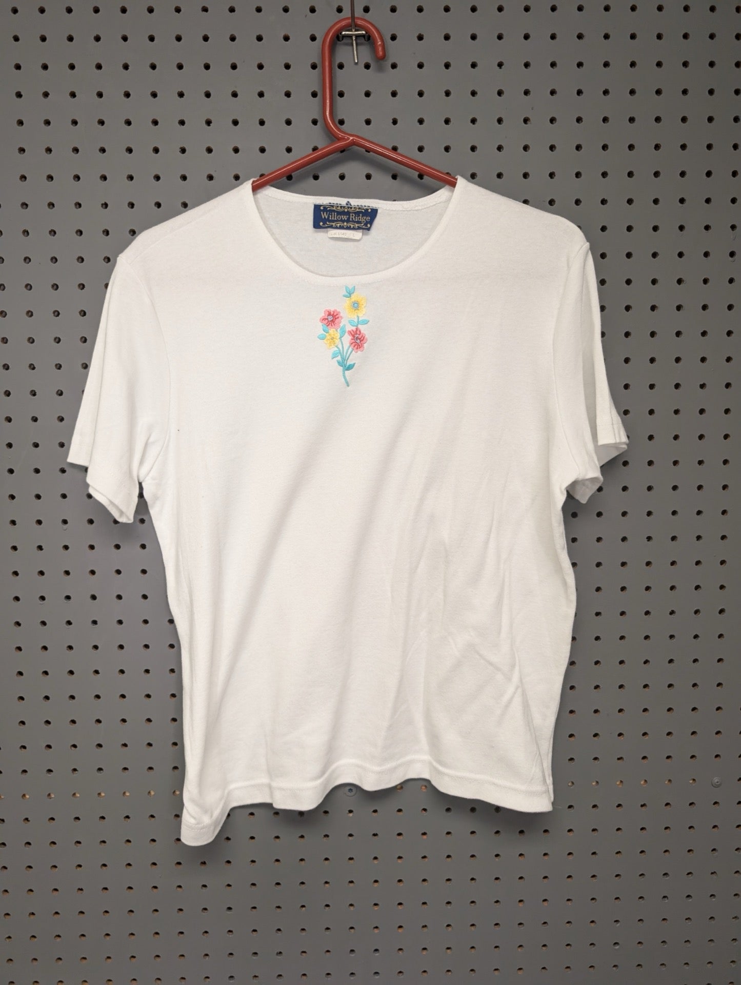 Front of white t-shirt with floral embroidery