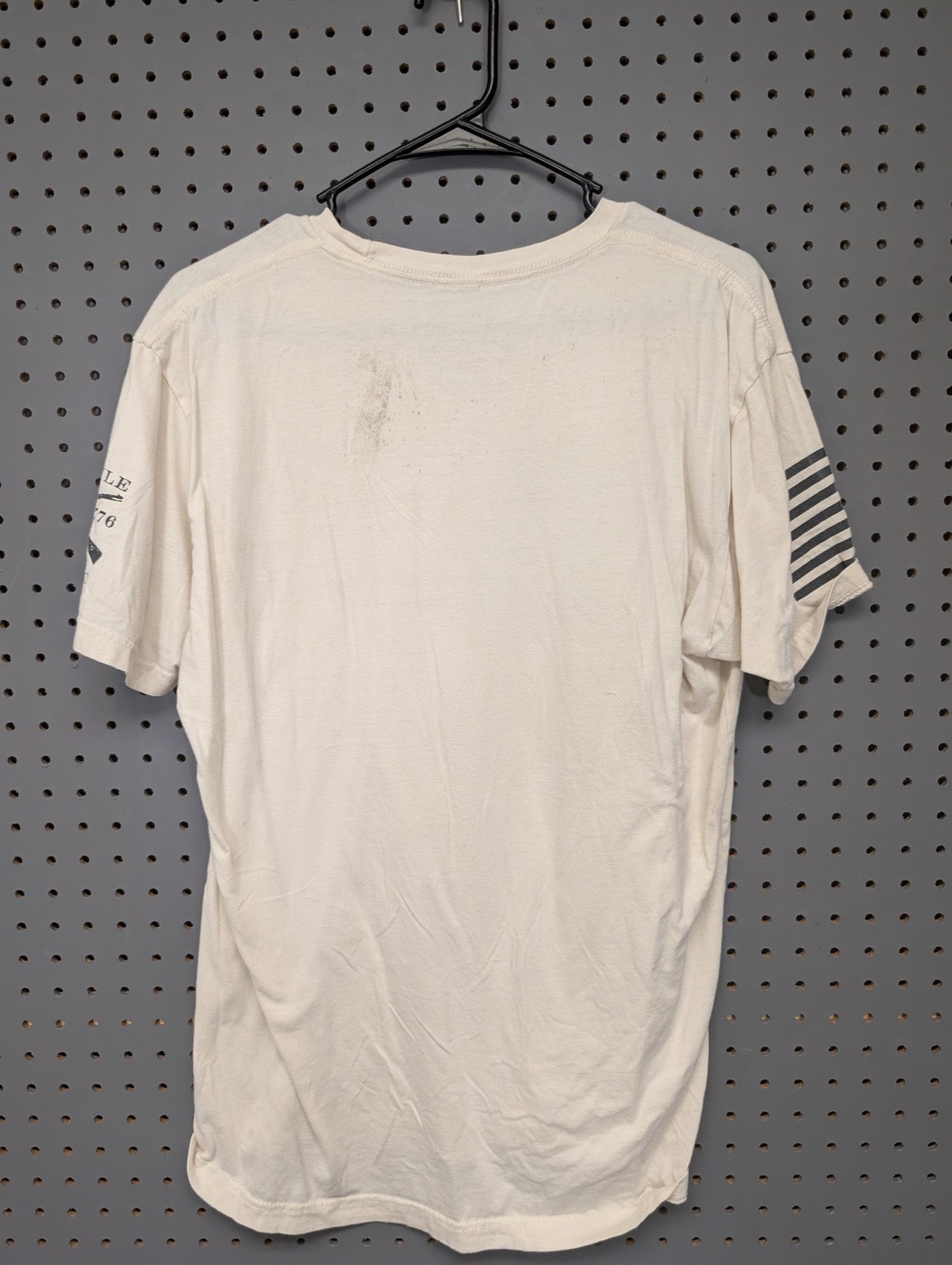 Back view of cream Grunt Style t-shirt showing sleeve graphic