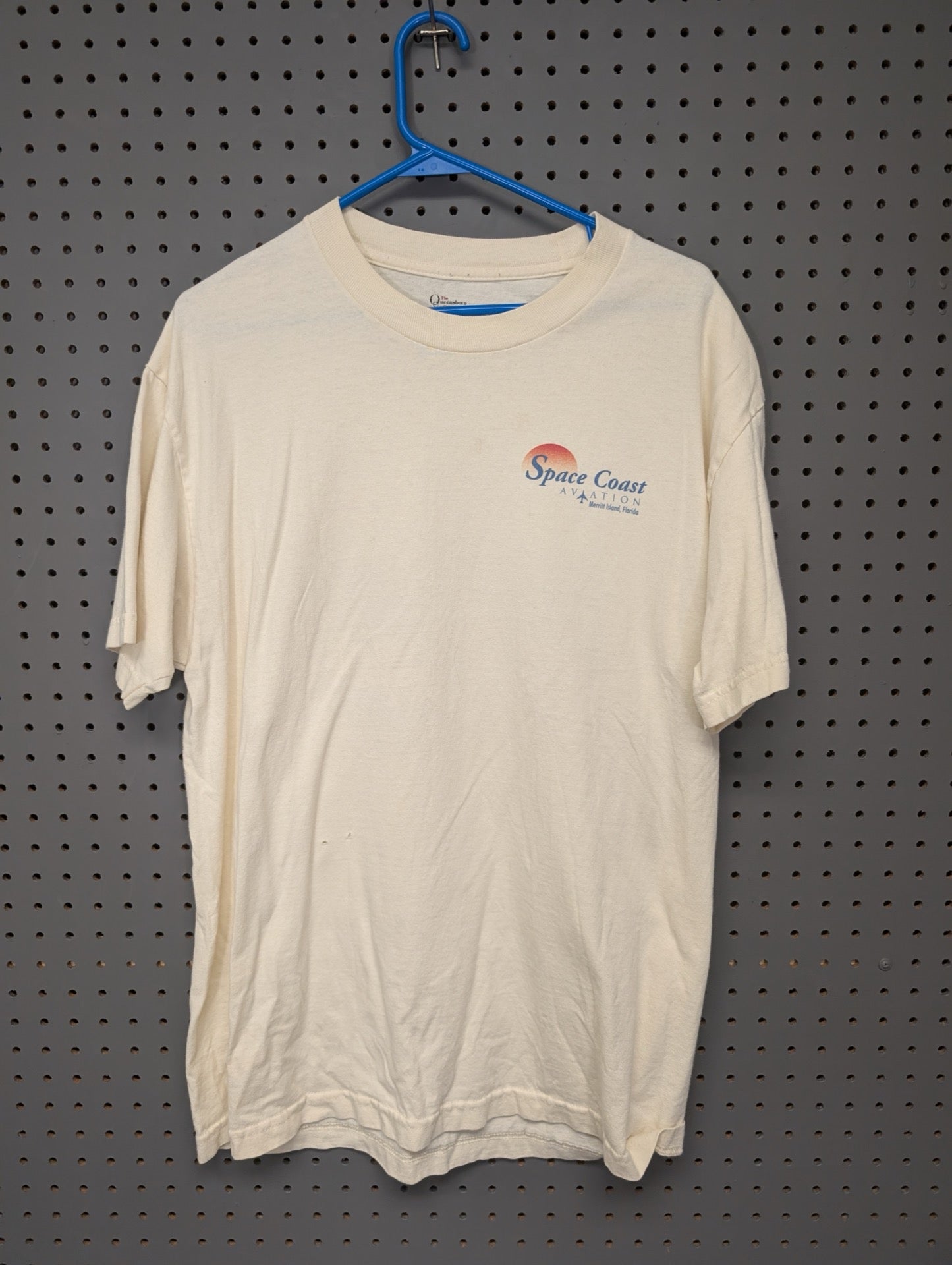 Front of cream t-shirt with Space Coast Aviation logo