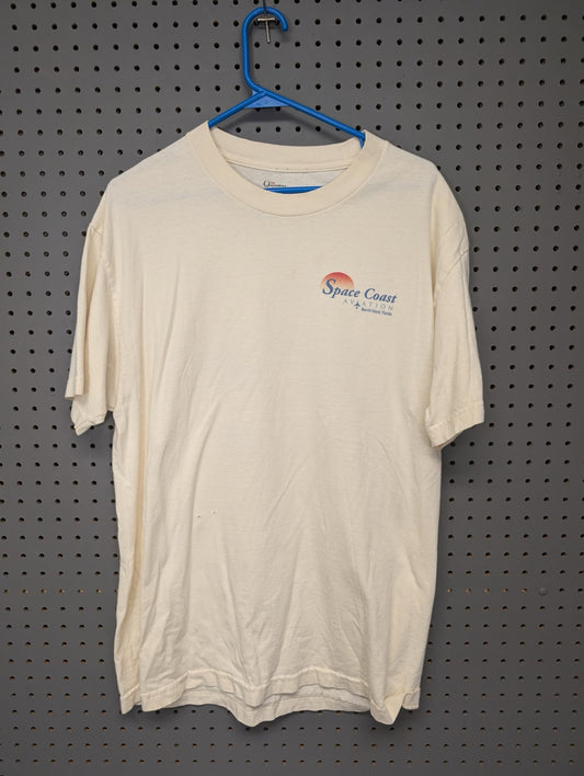 Front of cream t-shirt with Space Coast Aviation logo