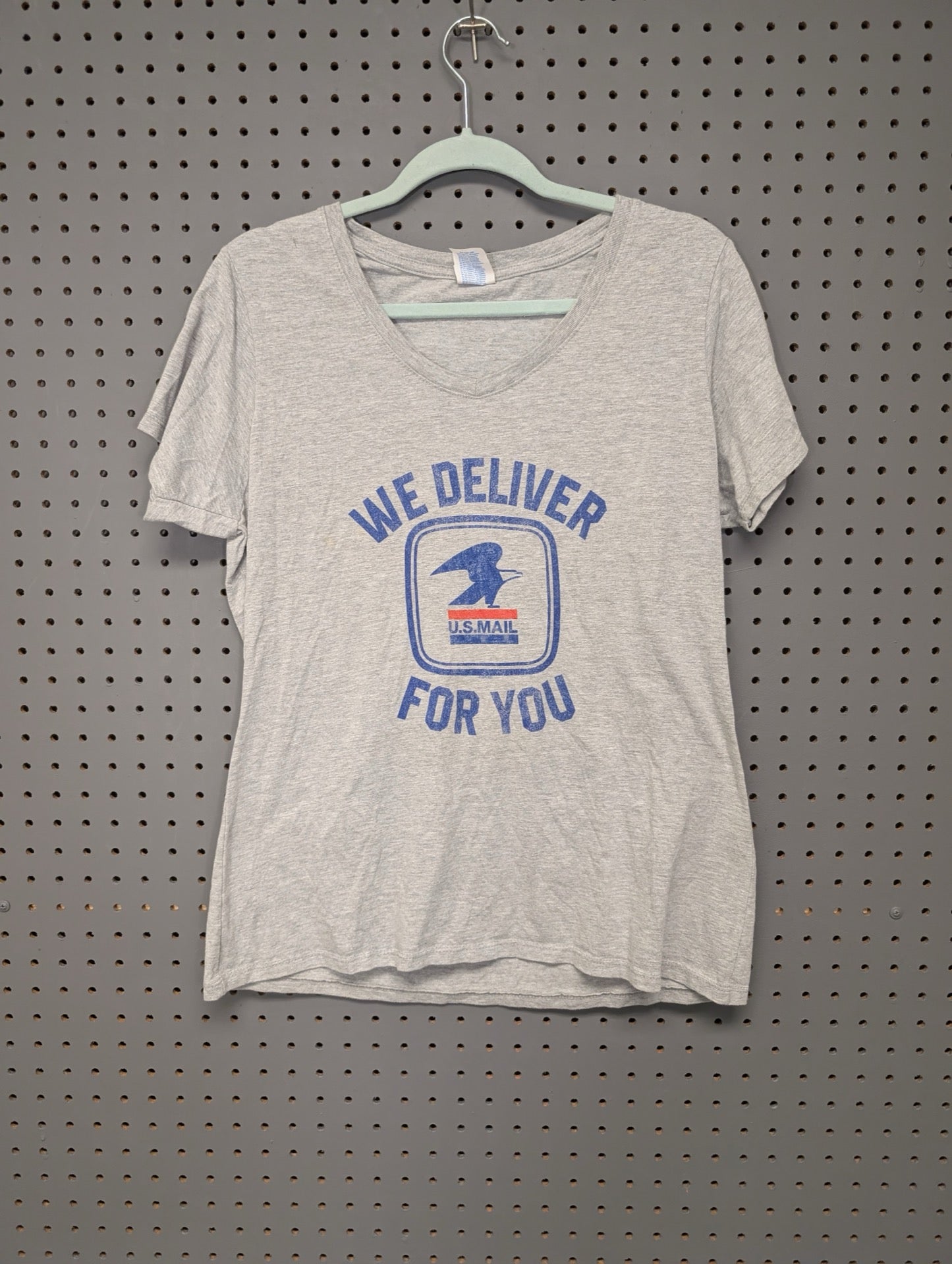 Front of grey v-neck t-shirt with USPS We Deliver For You graphic
