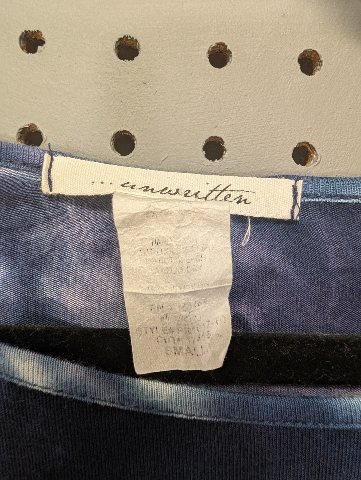 Unwritten brand tag inside shirt
