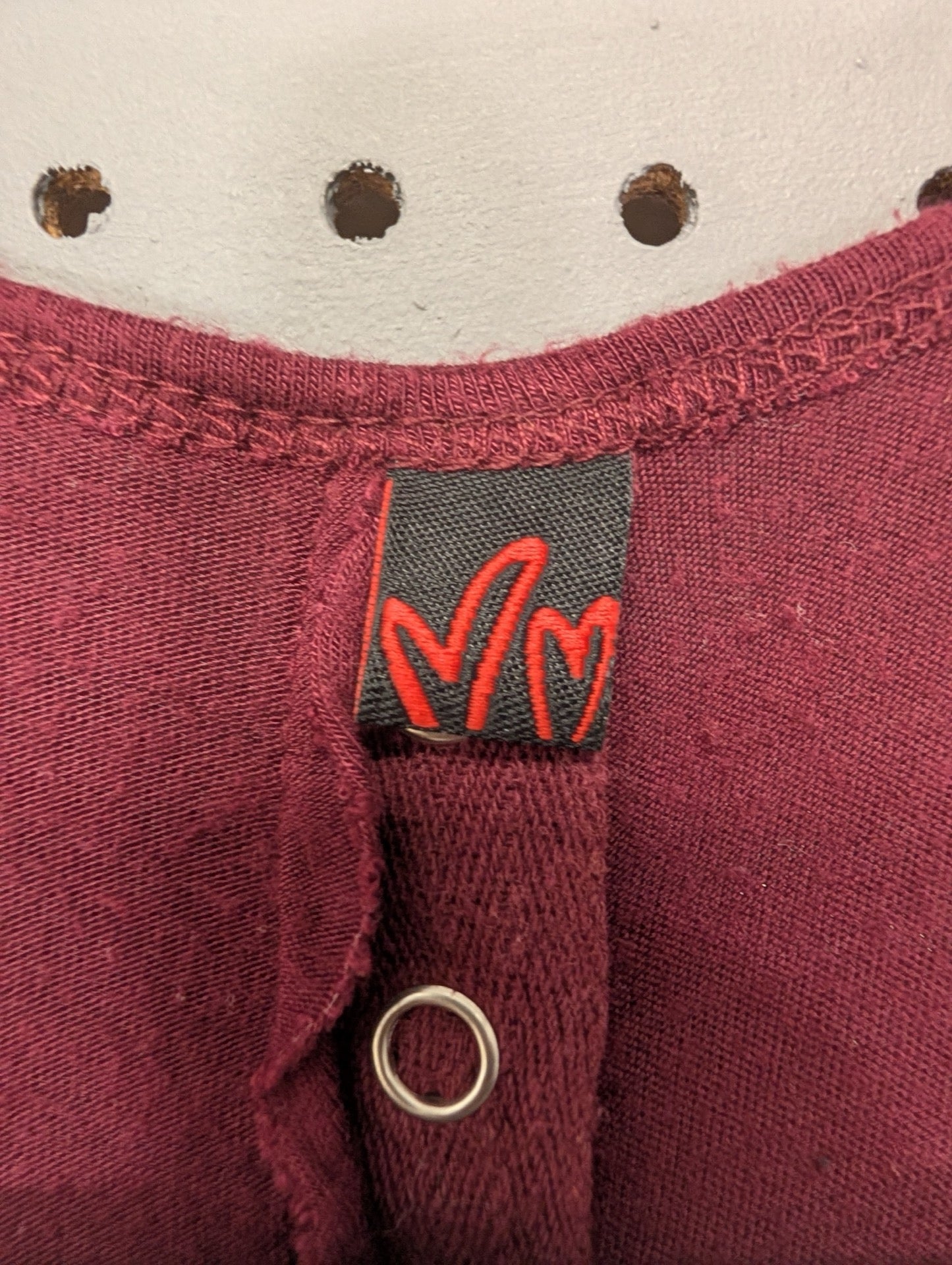Brand tag with red M logo