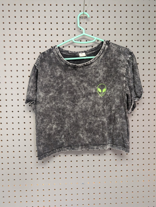Front of acid wash crop top with small alien graphic