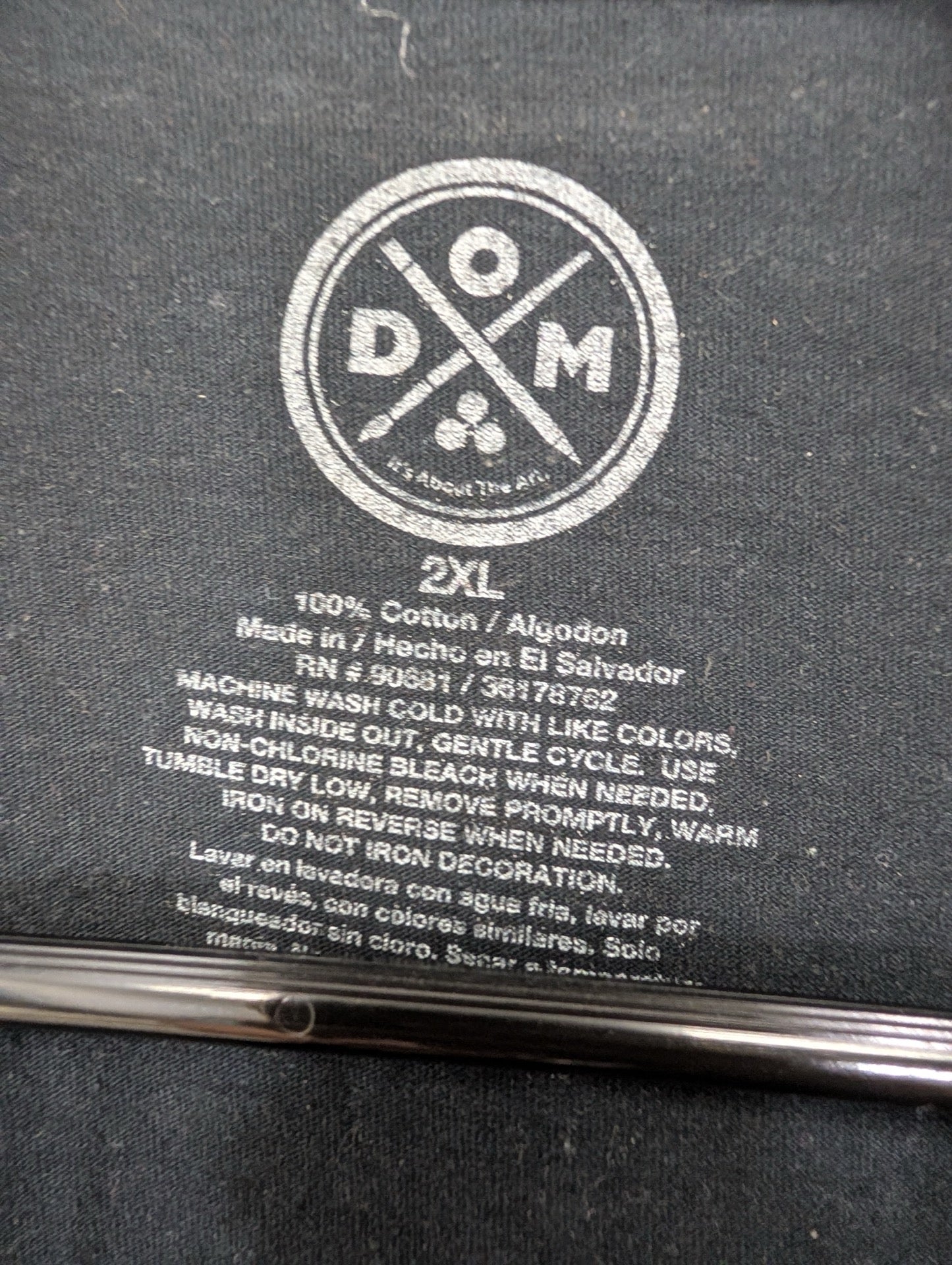 DXM 2XL brand tag printed on fabric