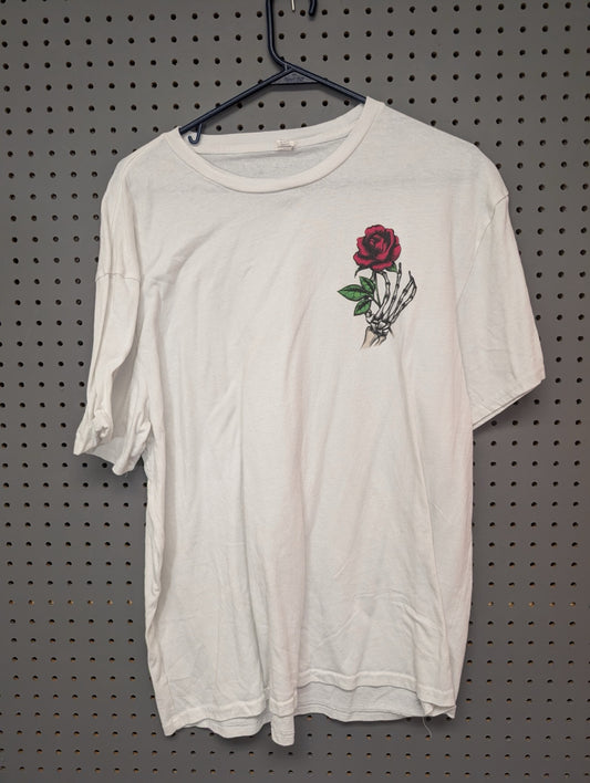 Front view of white t-shirt with skeleton hand and rose graphic