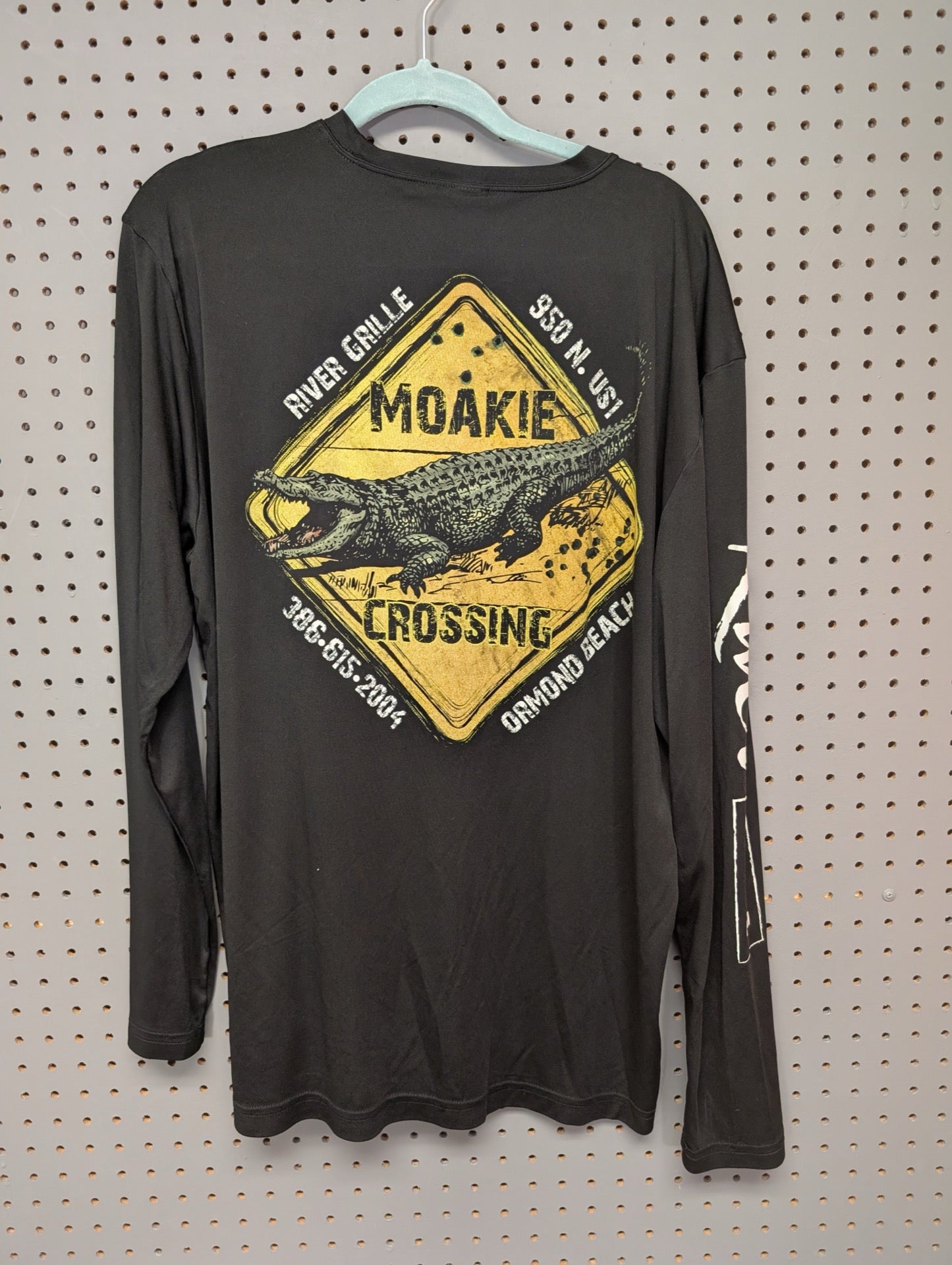 Back view of River Grille shirt showing alligator graphic